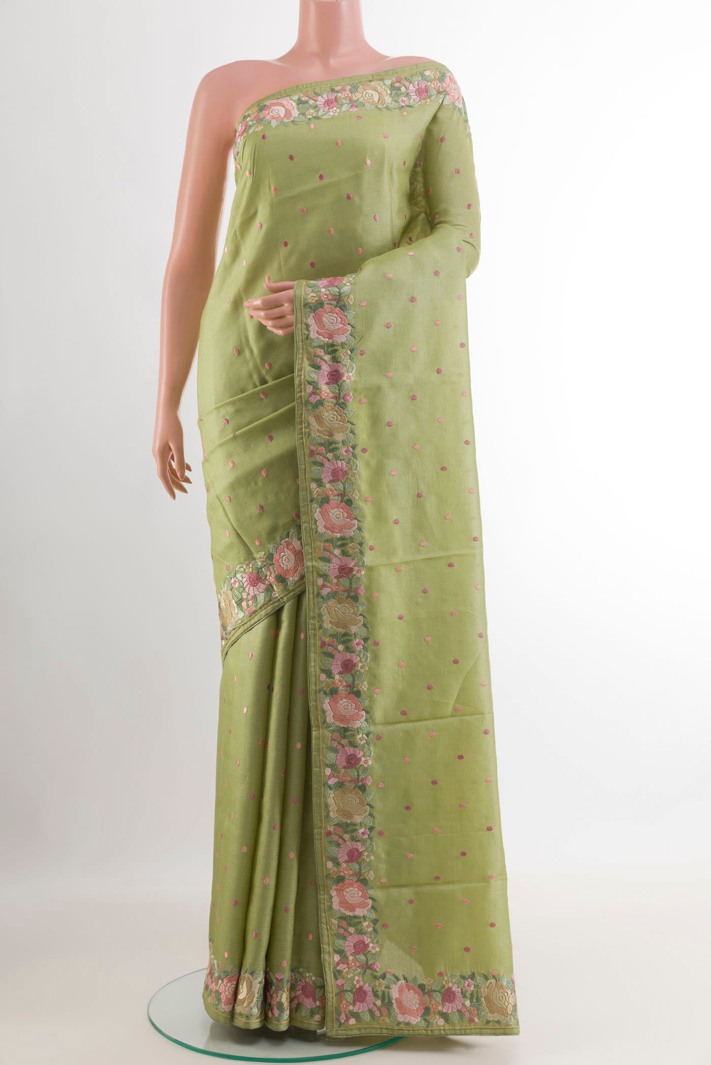 Green Tussar Saree with Embroidery on the body and Embroidery Border.  displayed on a mannequin
