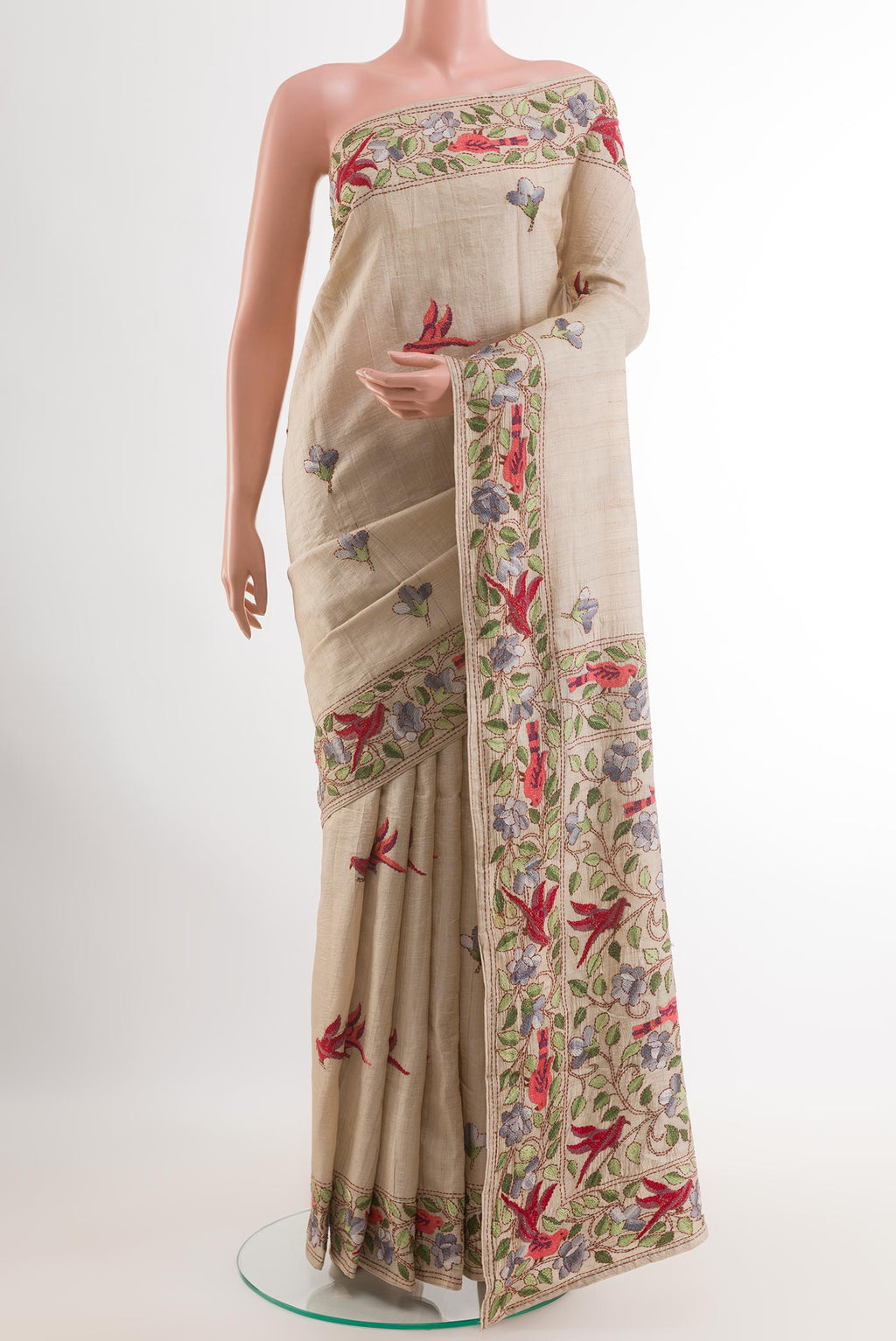 Cream Tussar Saree with Embroidery on the body and Embroidery Border.  displayed on a mannequin