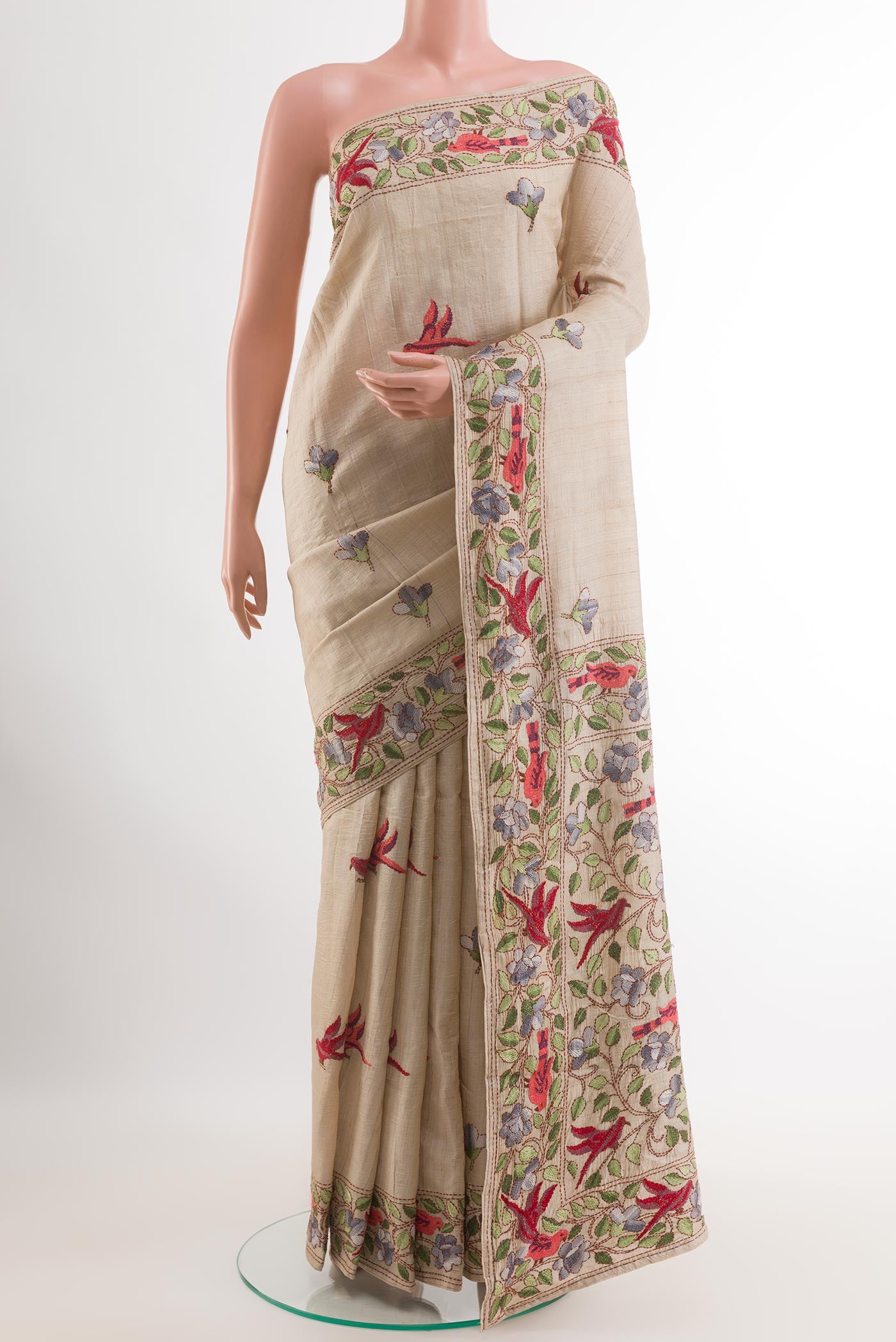 Cream Tussar Saree with Embroidery on the body and Embroidery Border.  displayed on a mannequin
