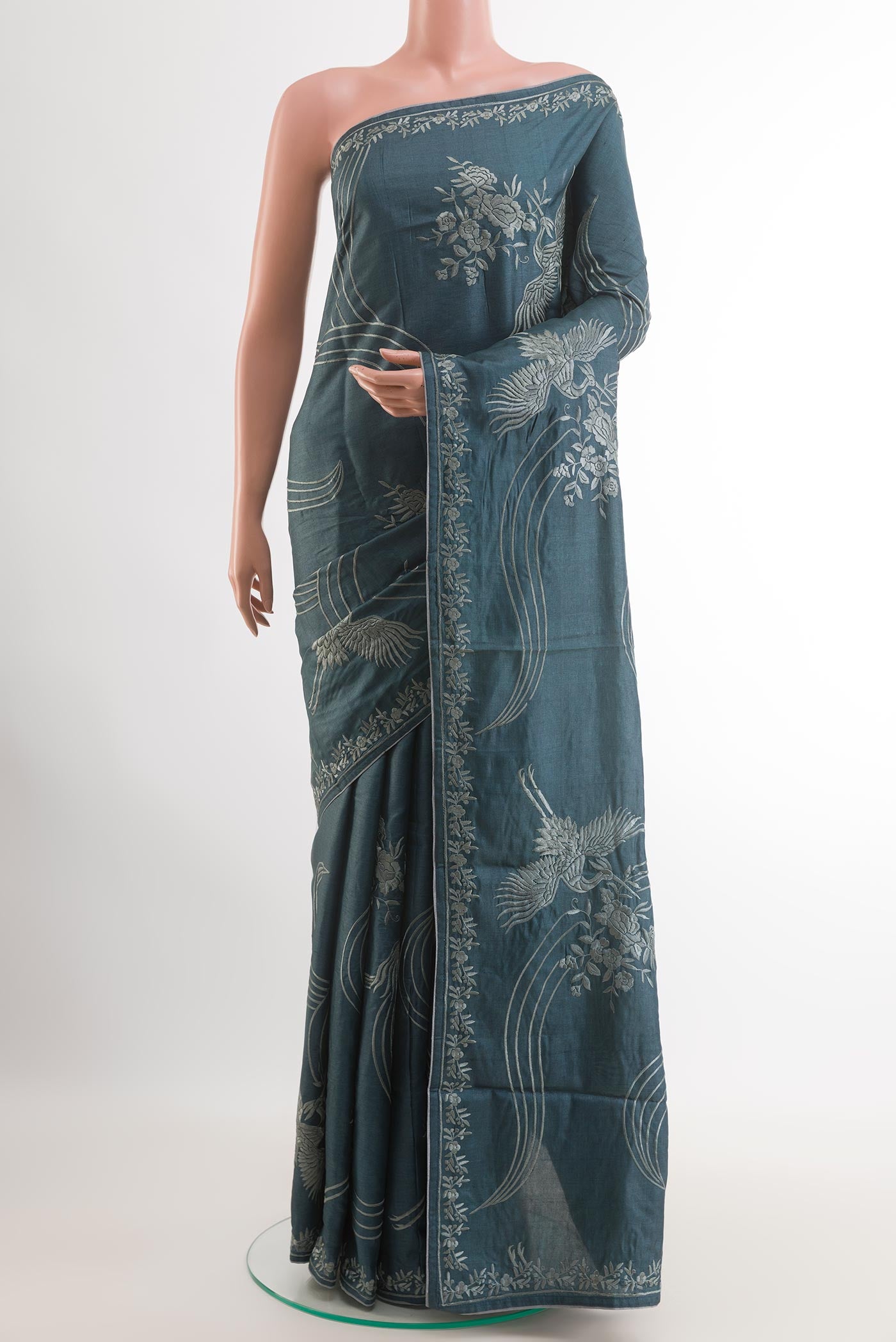 Blue Grey Tussar Saree with Embroidery on the body and Embroidery Border.  displayed on a mannequin