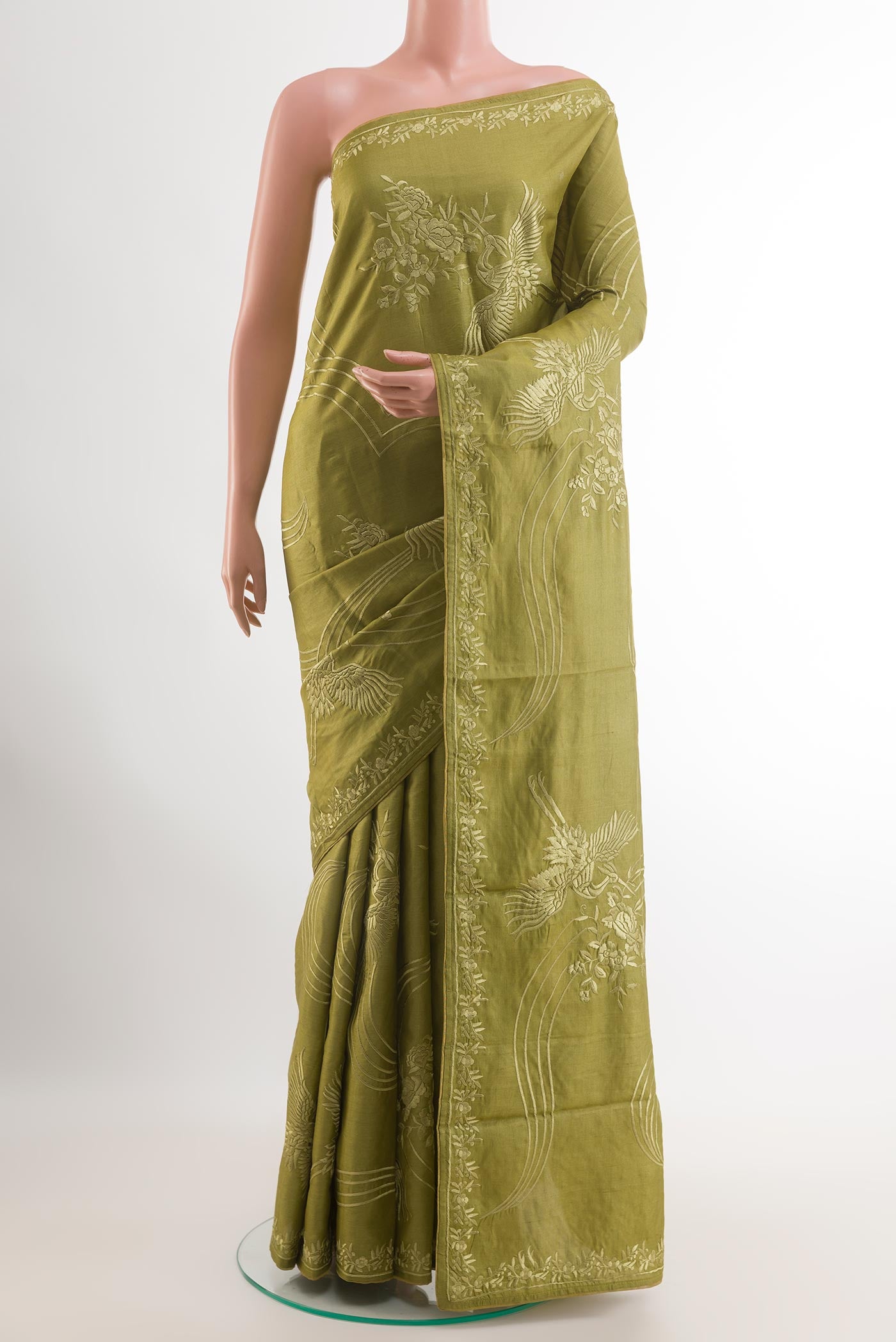 Green Tussar Saree with Embroidery on the body and Embroidery Border.  displayed on a mannequin