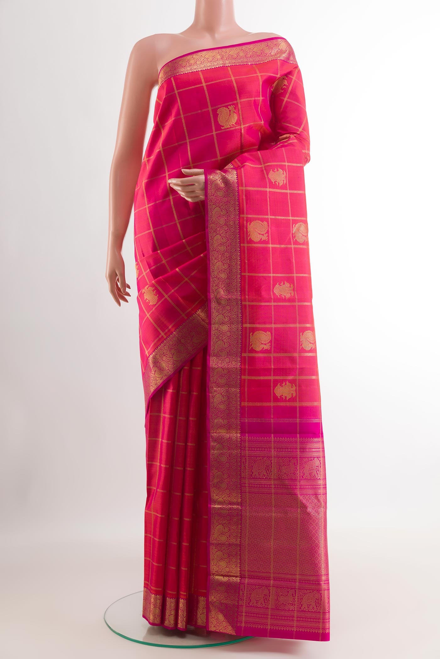 Pink Kanjivaram Silk Saree with Zari Butta on the body and Zari Border.  displayed on a mannequin