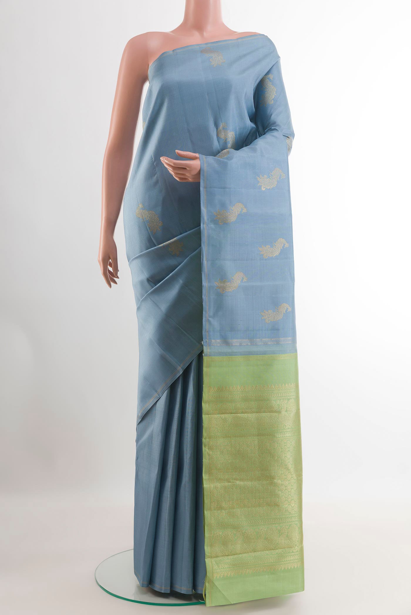 Blue Kanchipuram Silk Saree with Zari Butta on the body and Zari Border.  displayed on a mannequin