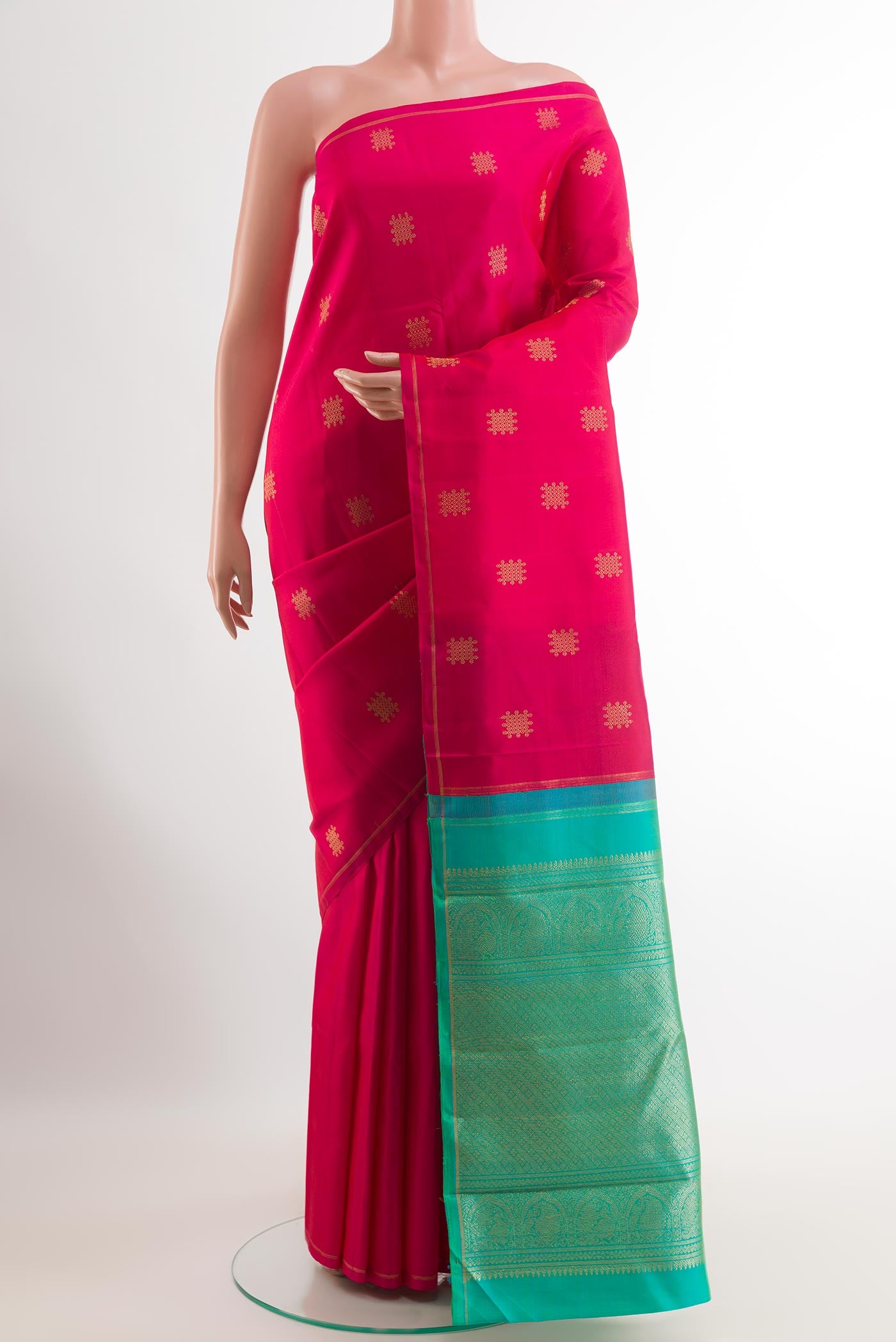 Pink Kanchipuram Silk Saree with Zari Butta on the body and Zari Border.  displayed on a mannequin
