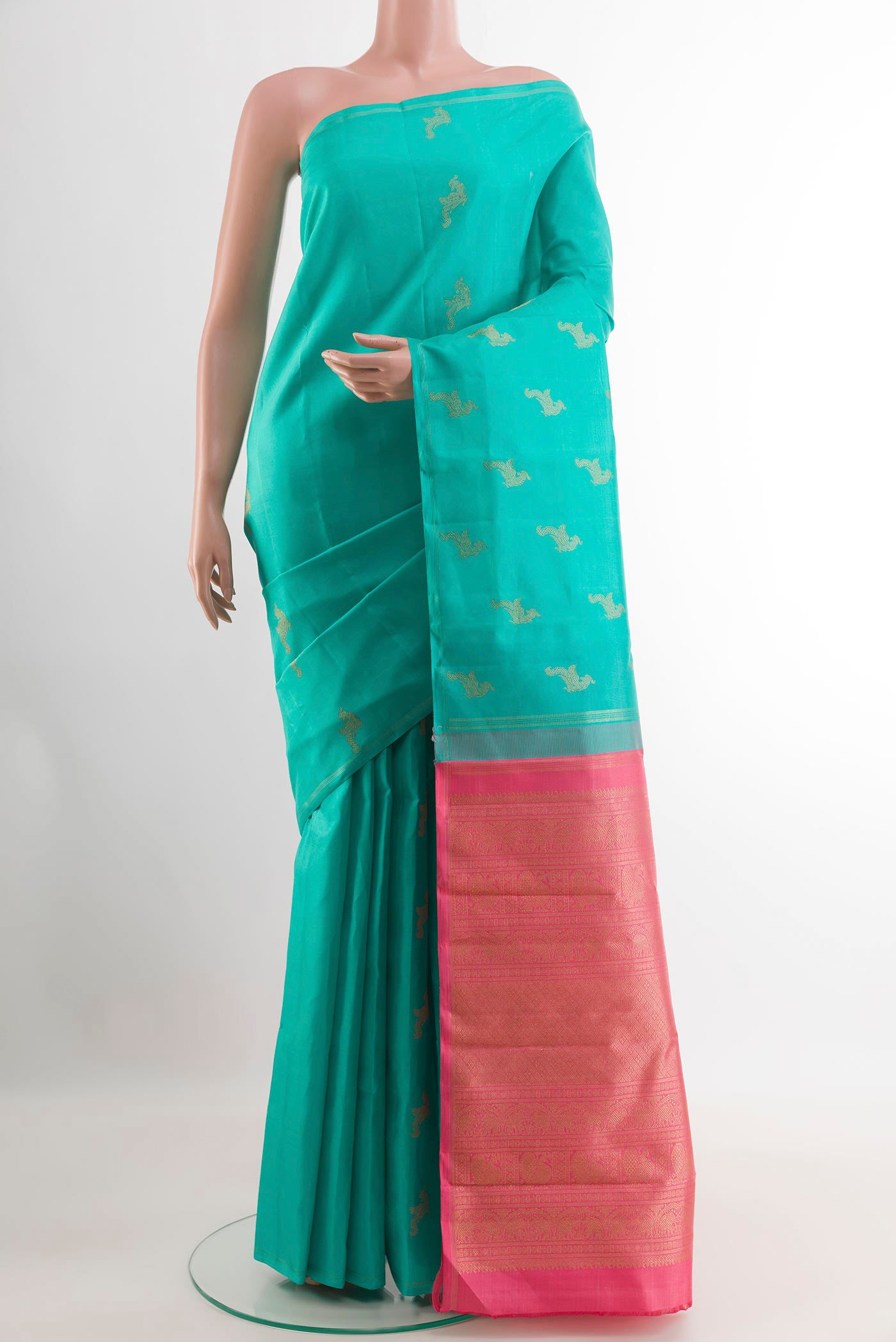 Sea Green Kanchipuram Silk Saree with Zari Butta on the body and Zari Border.  displayed on a mannequin