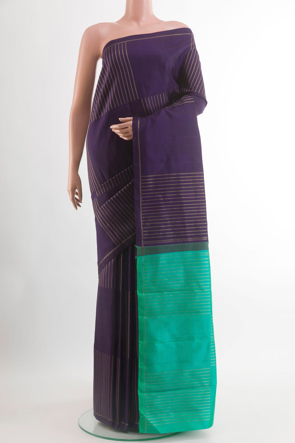 Purple Kanchipuram Silk Saree with Zari Butta on the body and Zari Border.  displayed on a mannequin