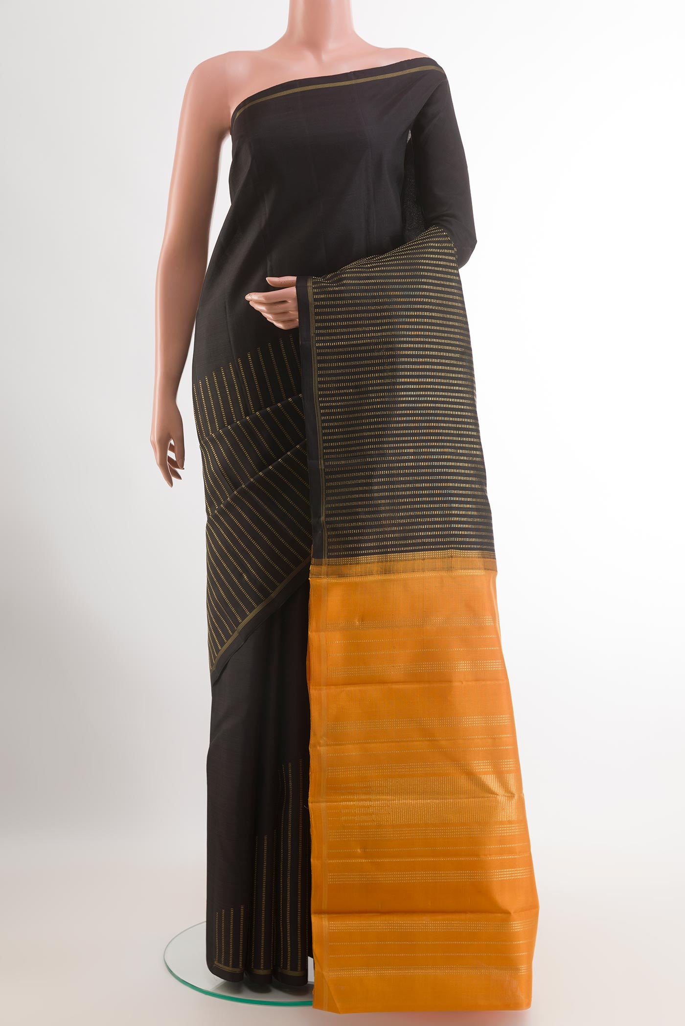 Black Kanchipuram Silk Saree with Stripes on the body and Zari Border.  displayed on a mannequin