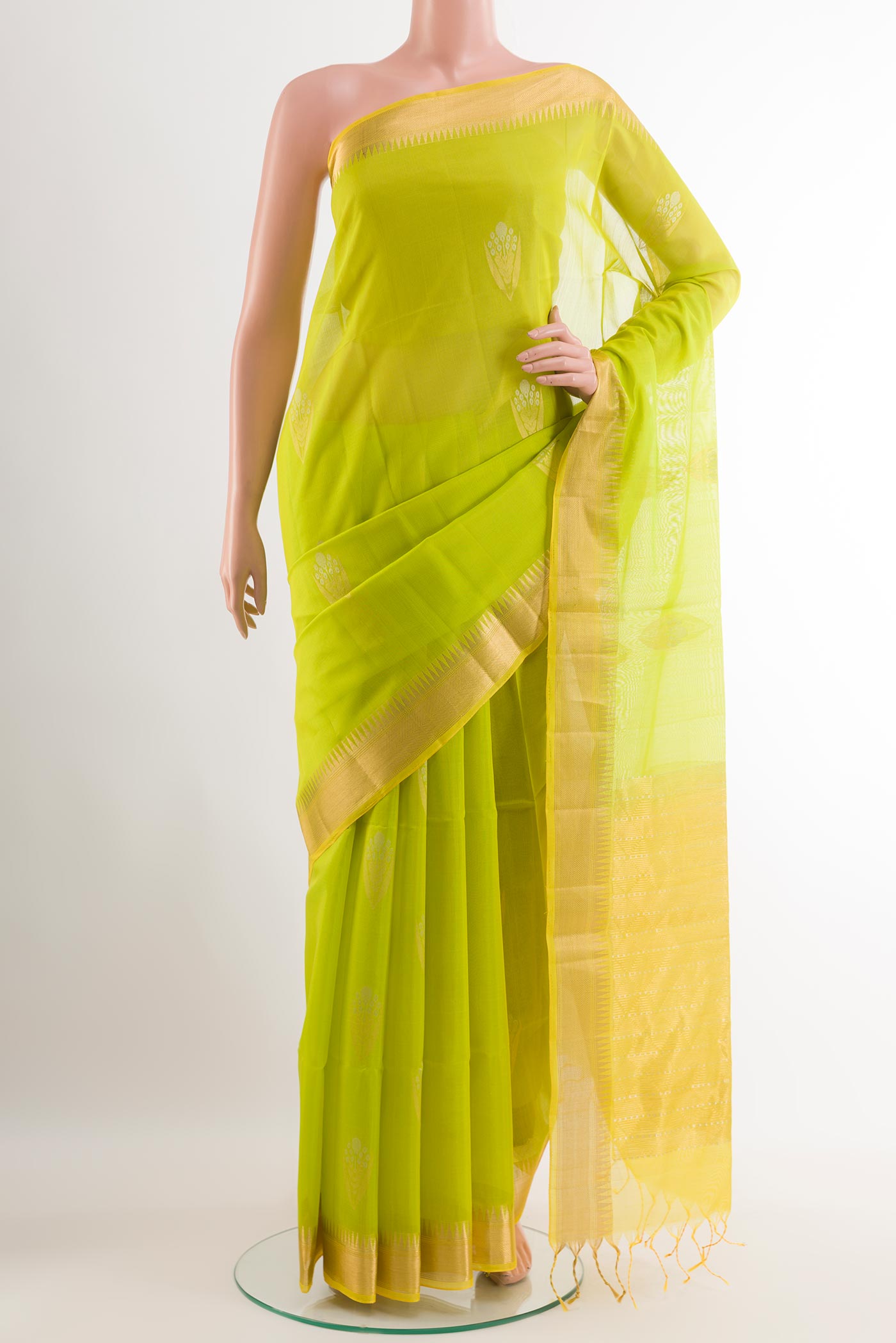Light Green Blended Kora Cotton Saree with Zari Butta on the body and Zari Border.  displayed on a mannequin