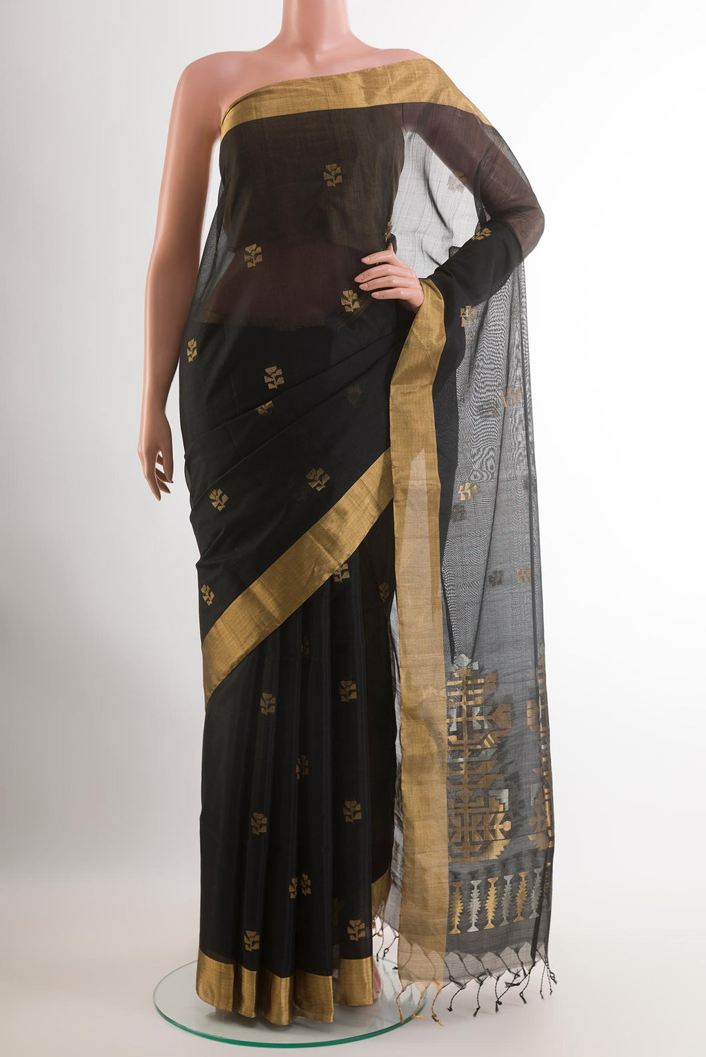Black Blended Kora Cotton Saree with Zari Butta on the body and Zari Border.  displayed on a mannequin