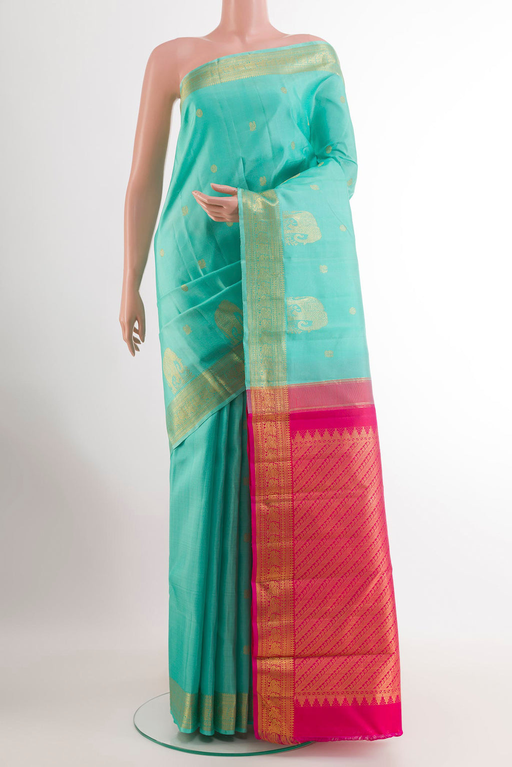 Sea Green Kanjivaram Silk Saree with Zari Butta on the body and Zari Border.  displayed on a mannequin