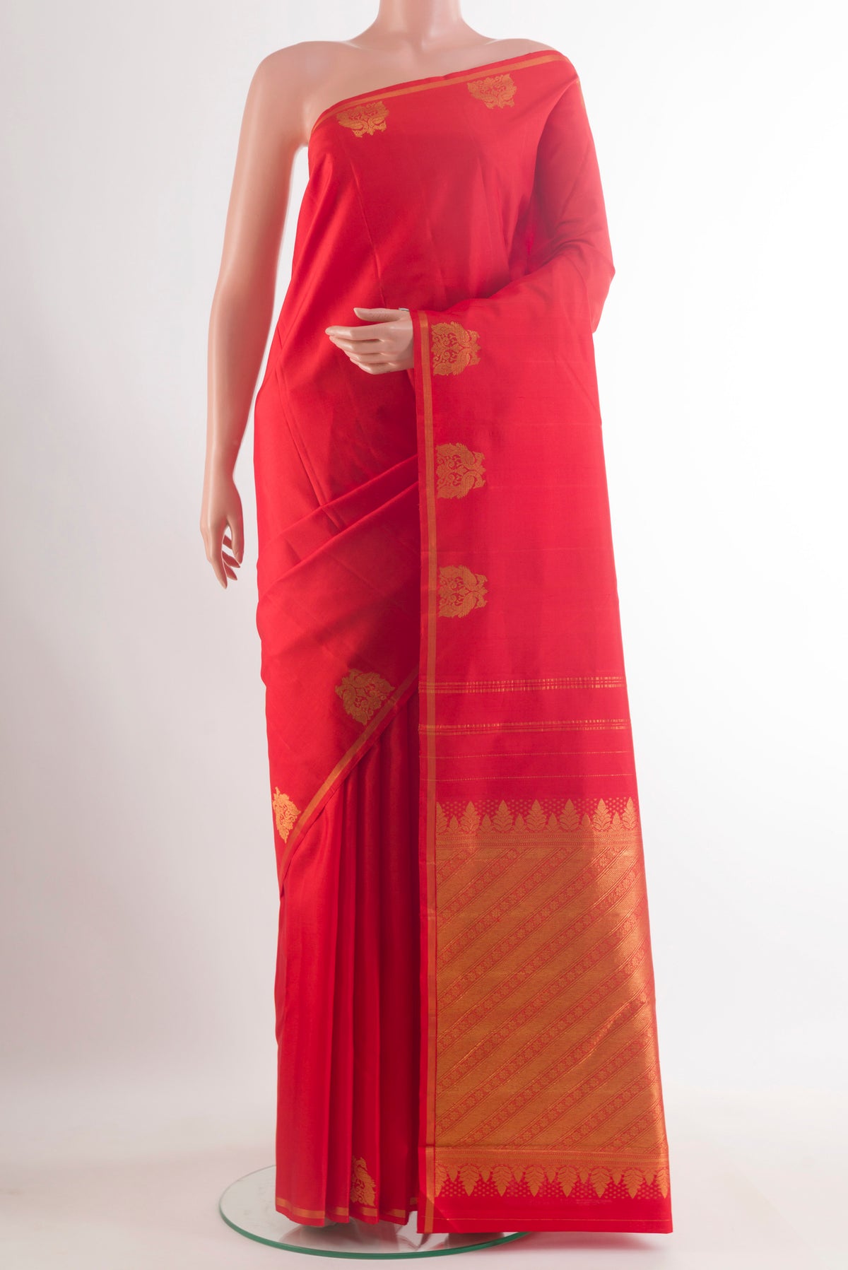 Pure Silk Red Kanchipuram Saree with Plain Body and Zari Border.  displayed on a mannequin
