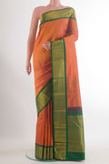 Pure Silk Brick Orange Kanjivaram Saree with Plain Body and Zari Border.  displayed on a mannequin