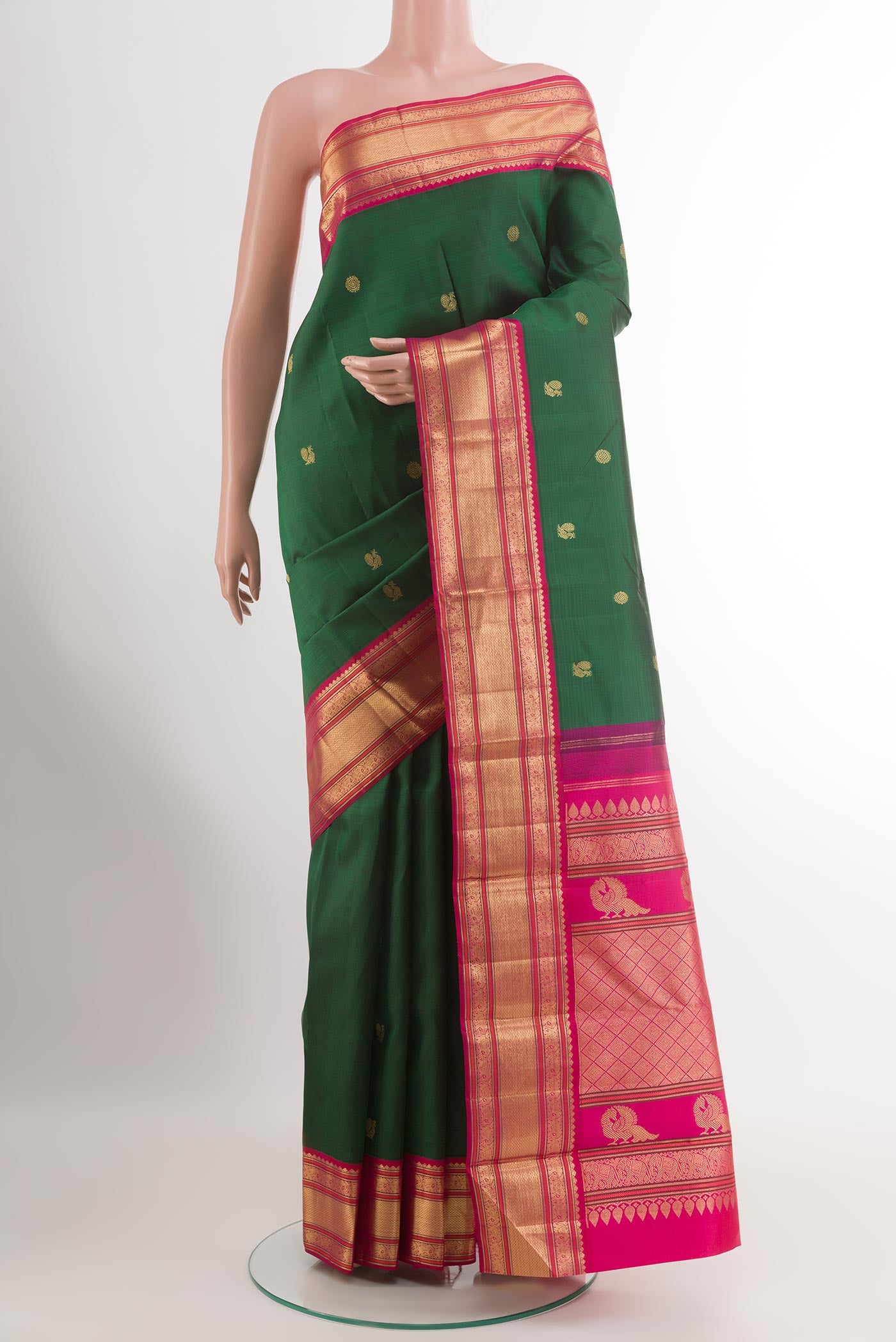 Green Kanjivaram Silk Saree with Zari Butta on the body and Zari Border.  displayed on a mannequin