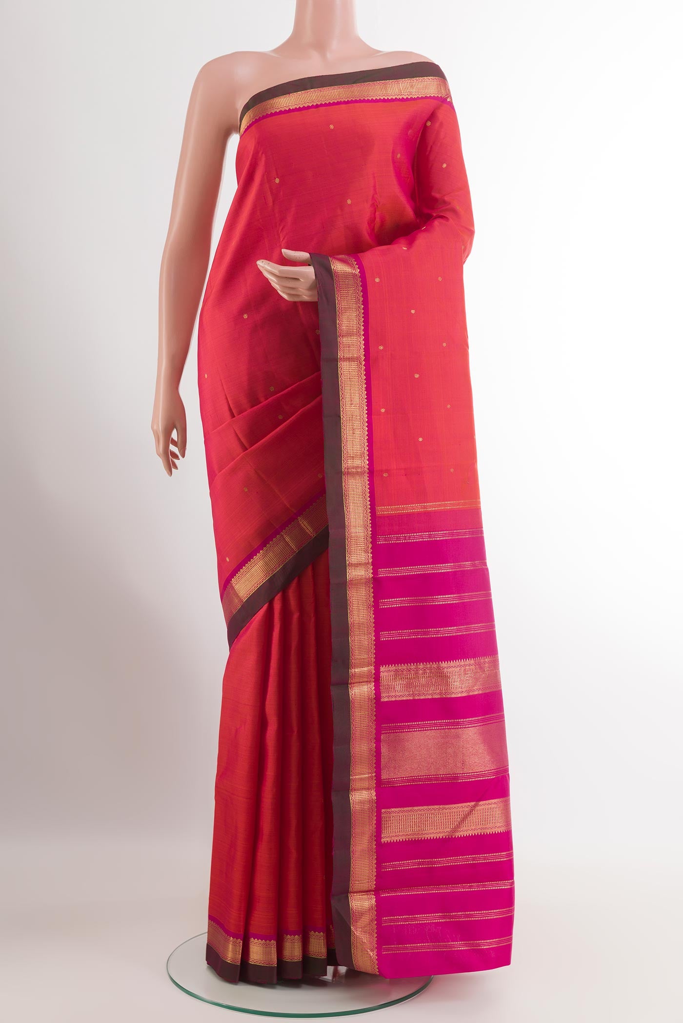 Red Kanchipuram Silk Saree with Zari Butta on the body and Zari Border.  displayed on a mannequin