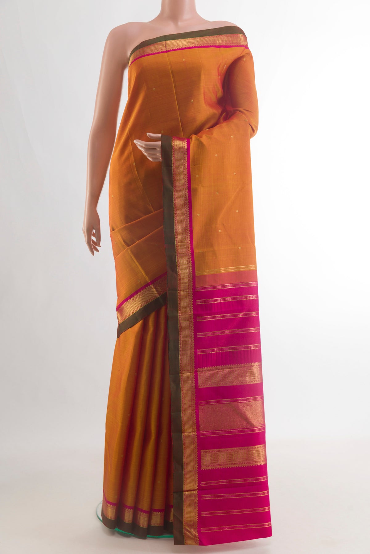 Pure Silk Mustard Kanchipuram Saree with Zari Butta on the body and Zari Border.  displayed on a mannequin