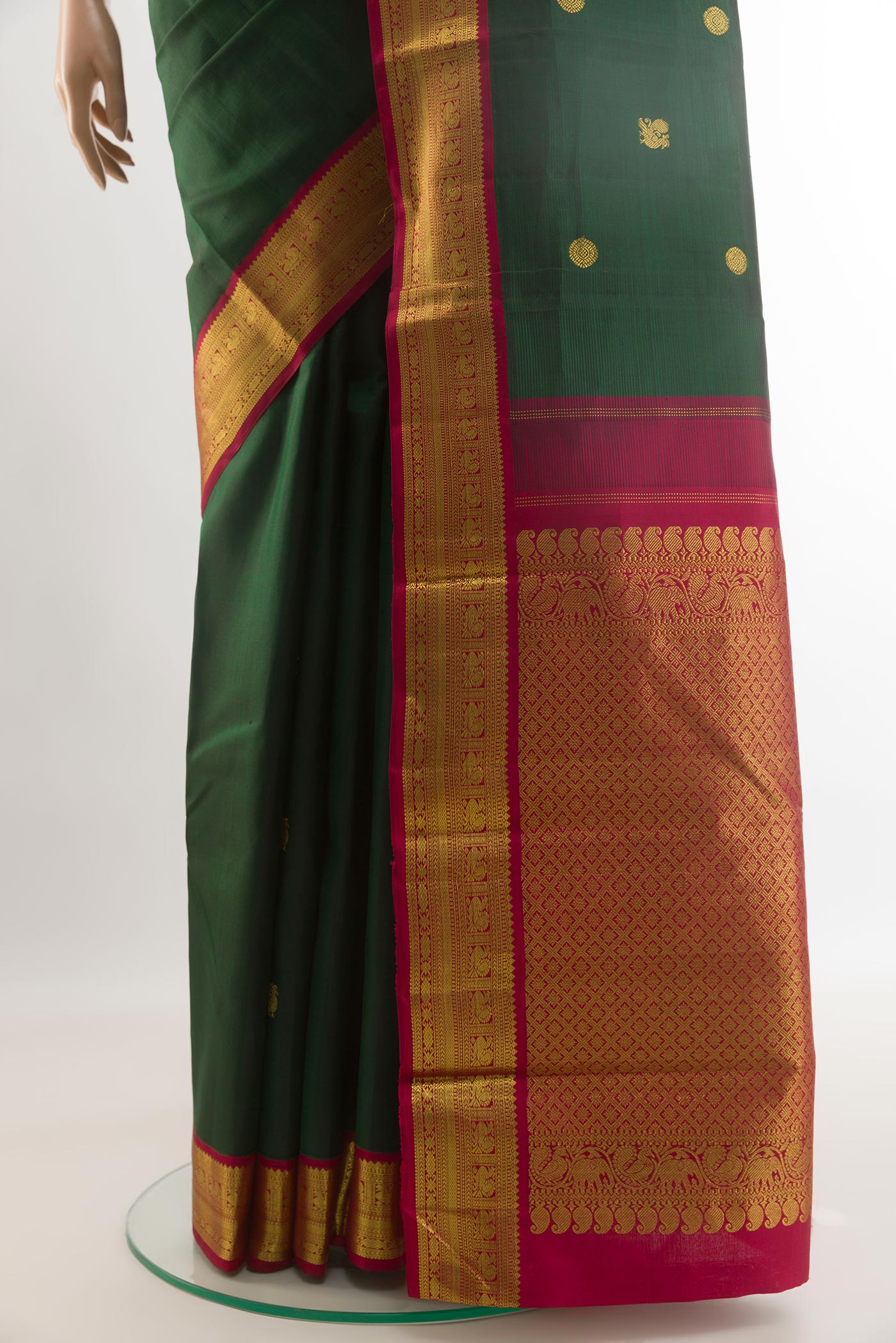Pleats and pallu of Bottle Green Kanjivaram Silk Saree with Zari Butta on the body and Zari Border. 