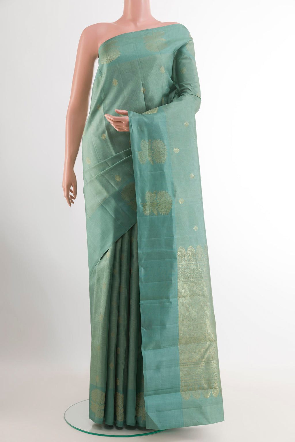 Sage Green Kanchipuram Silk Saree with Zari Butta on the body and Zari Border.  displayed on a mannequin