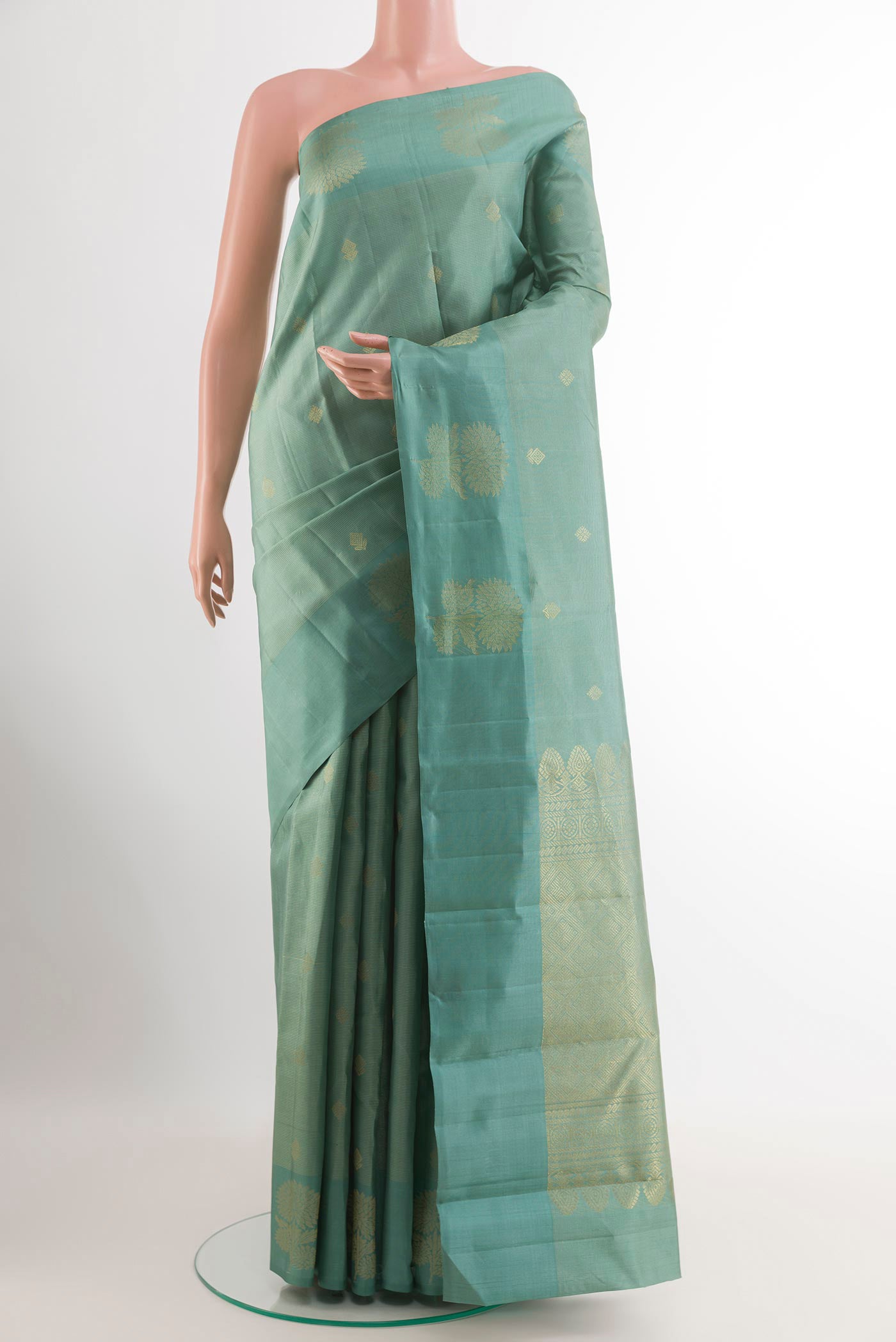 Sage Green Kanchipuram Silk Saree with Zari Butta on the body and Zari Border.  displayed on a mannequin