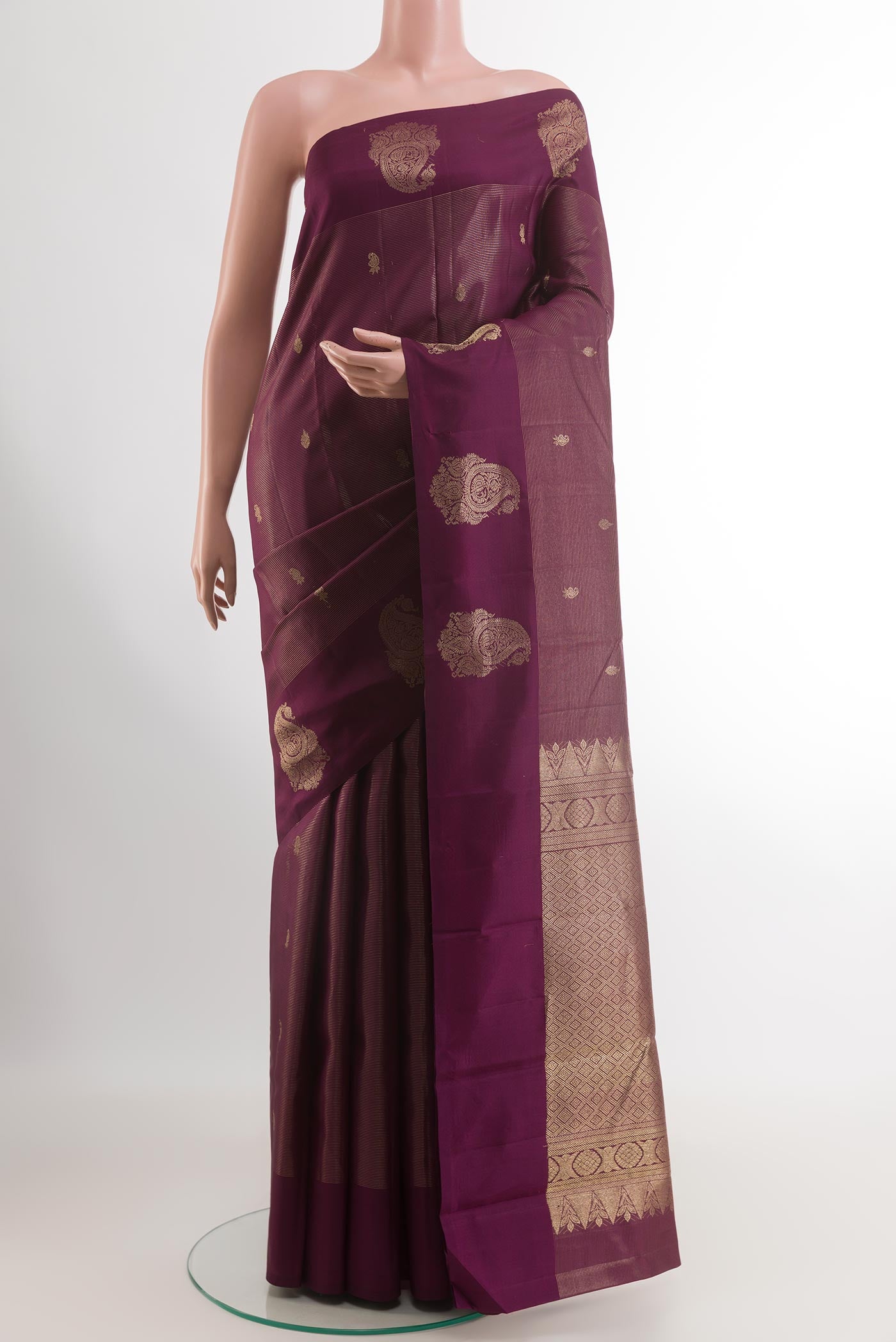 Purple Kanchipuram Silk Saree with Zari Butta on the body and Zari Border.  displayed on a mannequin
