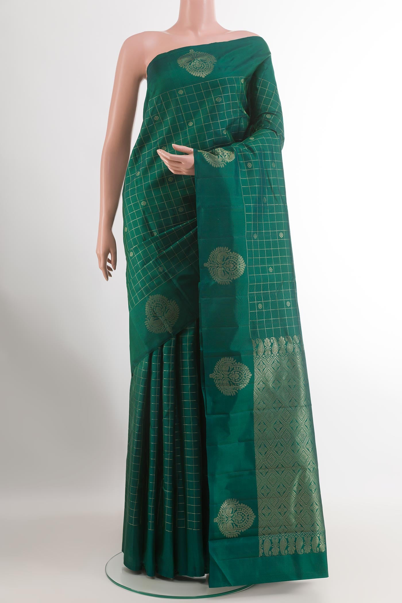 Green Kanchipuram Silk Saree with Checked design on the body and Zari Border.  displayed on a mannequin