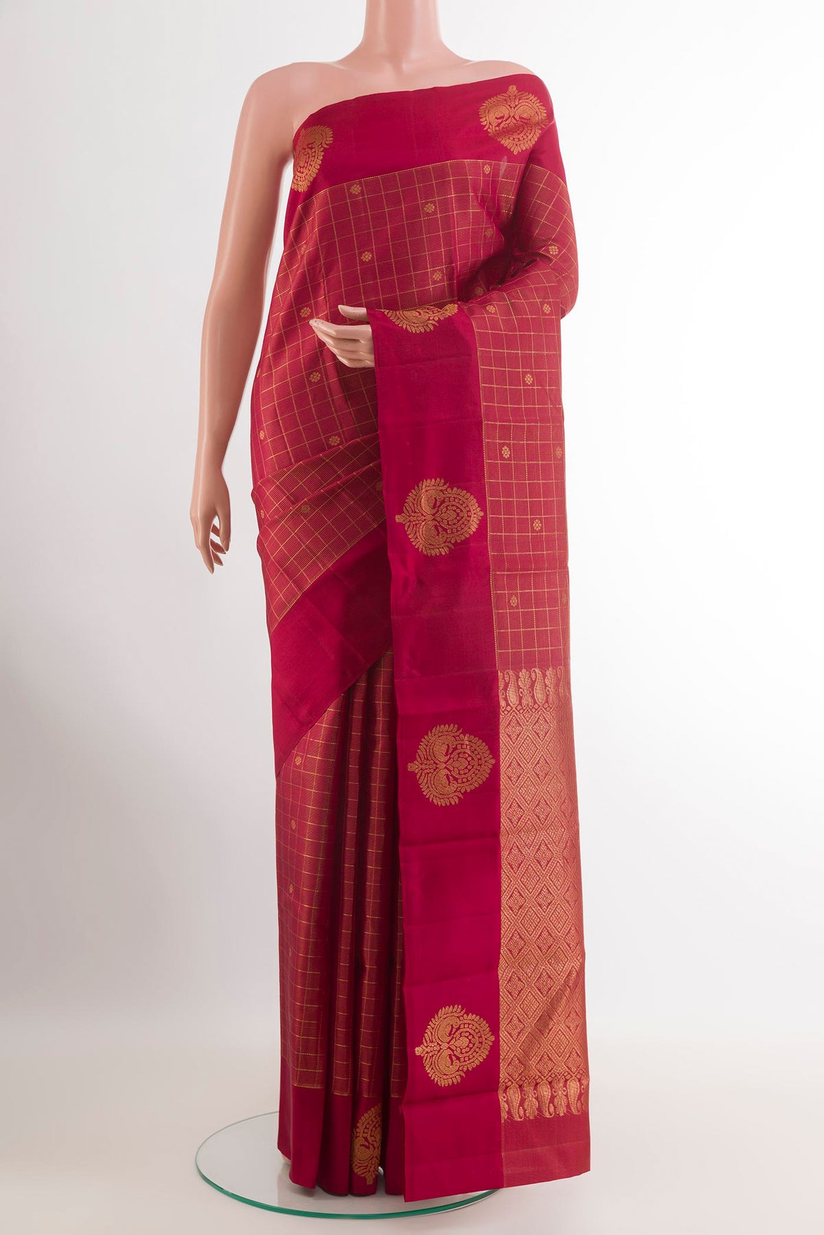 Maroon Kanjivaram Silk Saree with Checked design on the body and Zari Border.  displayed on a mannequin