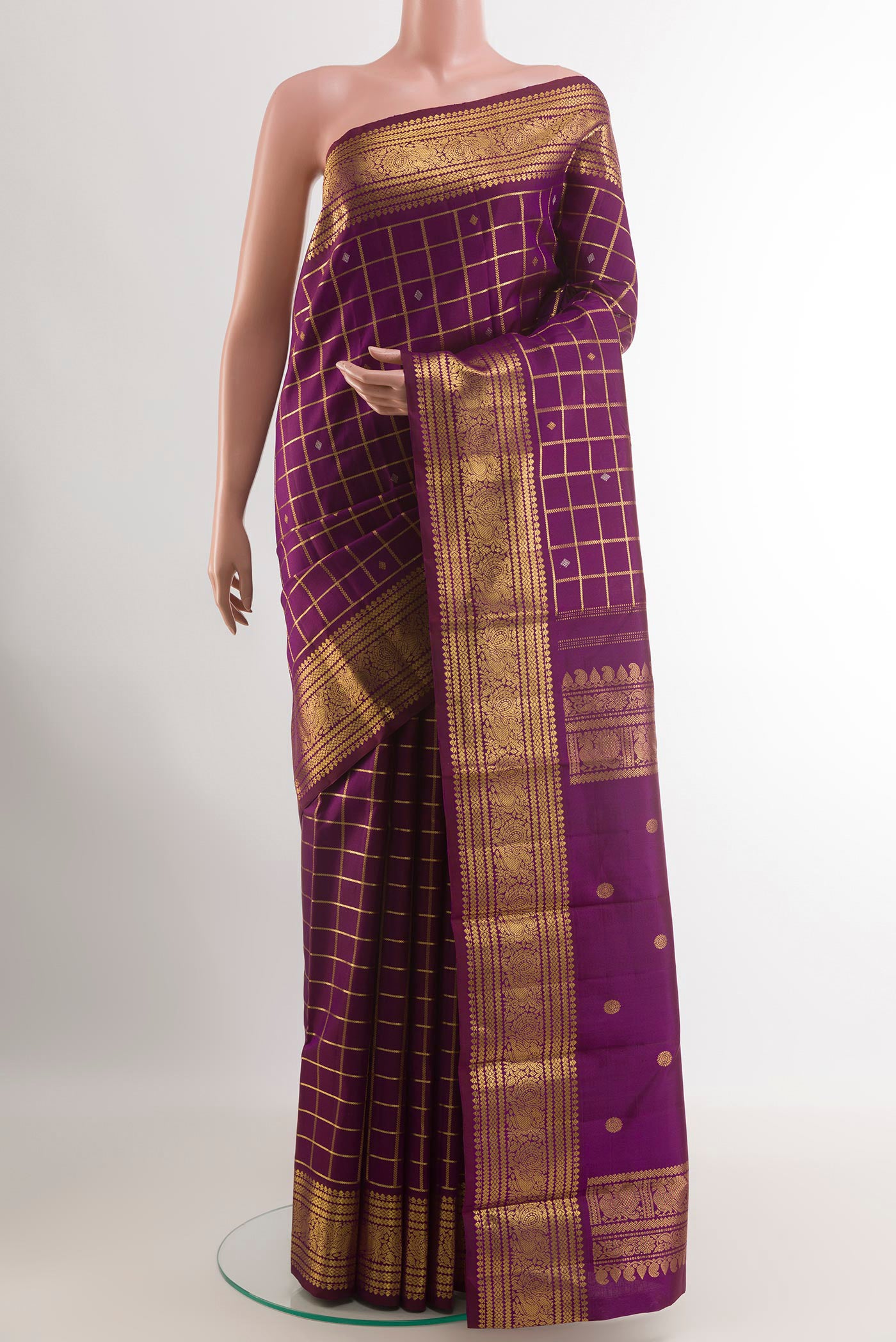 Purple Kanjivaram Silk Saree with Zari Butta on the body and Zari Border.  displayed on a mannequin