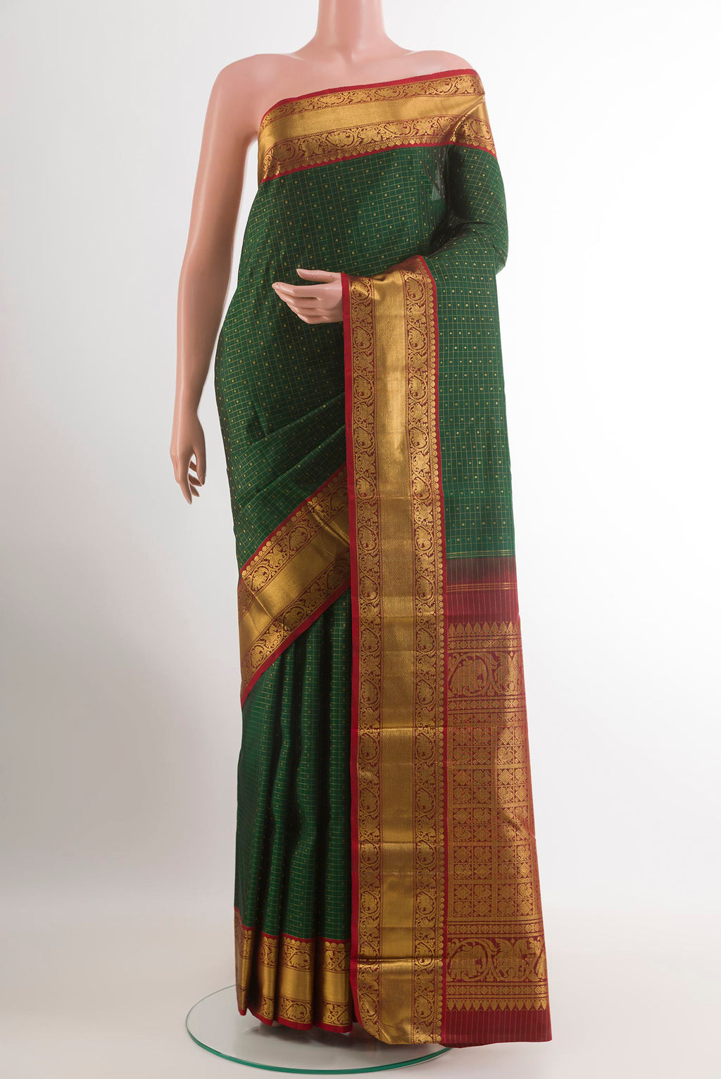 Green Kanjivaram Silk Saree with Zari Butta on the body and Zari Border.  displayed on a mannequin