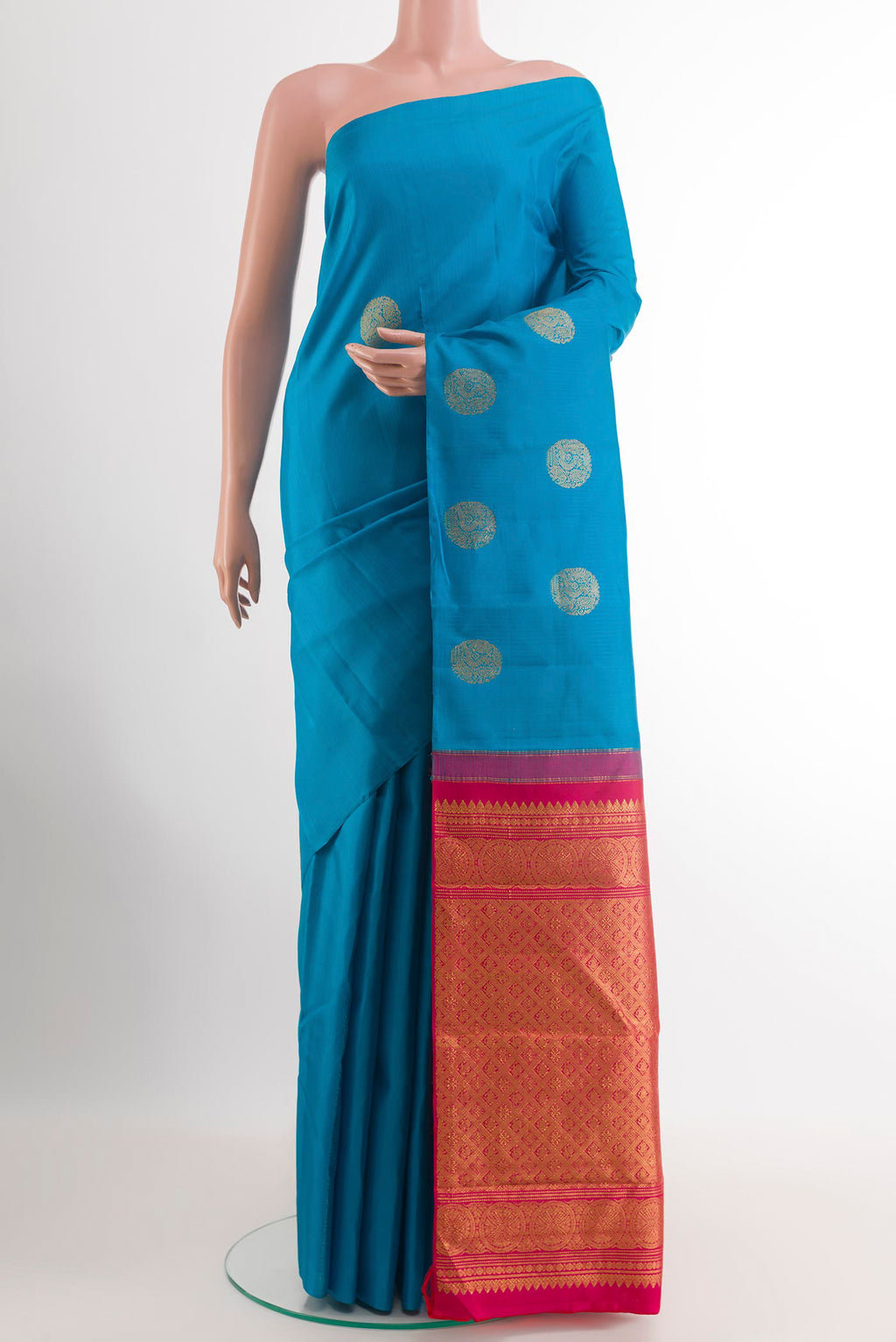 Blue Kanchipuram Silk Saree with Zari Butta on the body and Zari Border.  displayed on a mannequin