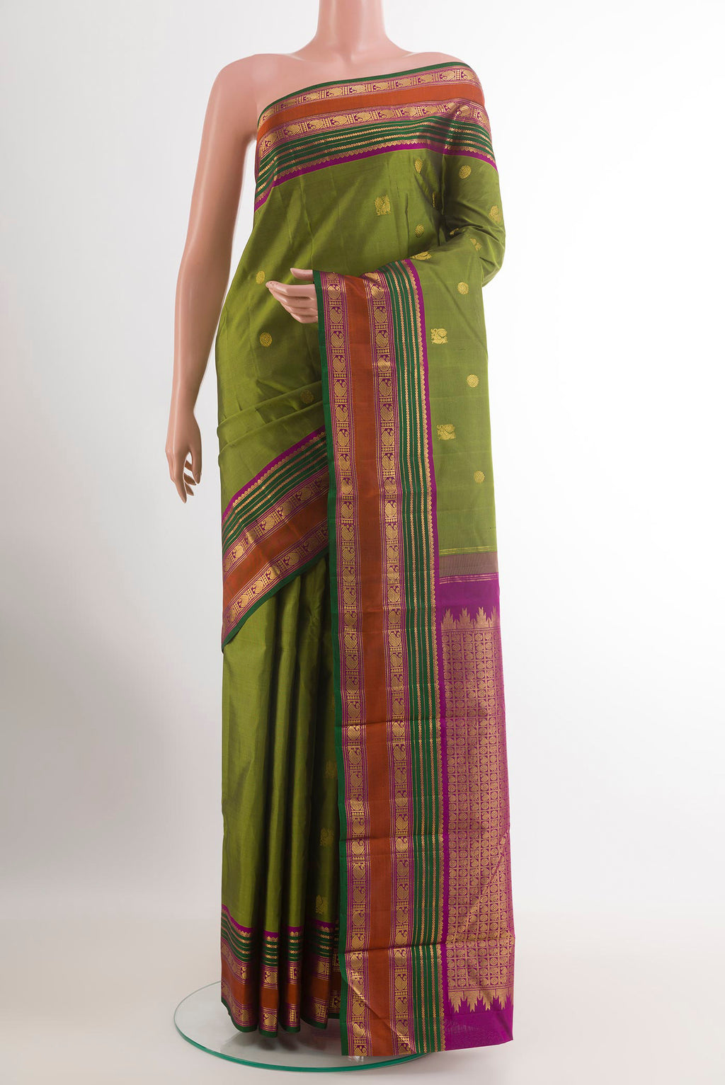 Green Kanchipuram Silk Saree with Zari Butta on the body and Zari Border.  displayed on a mannequin
