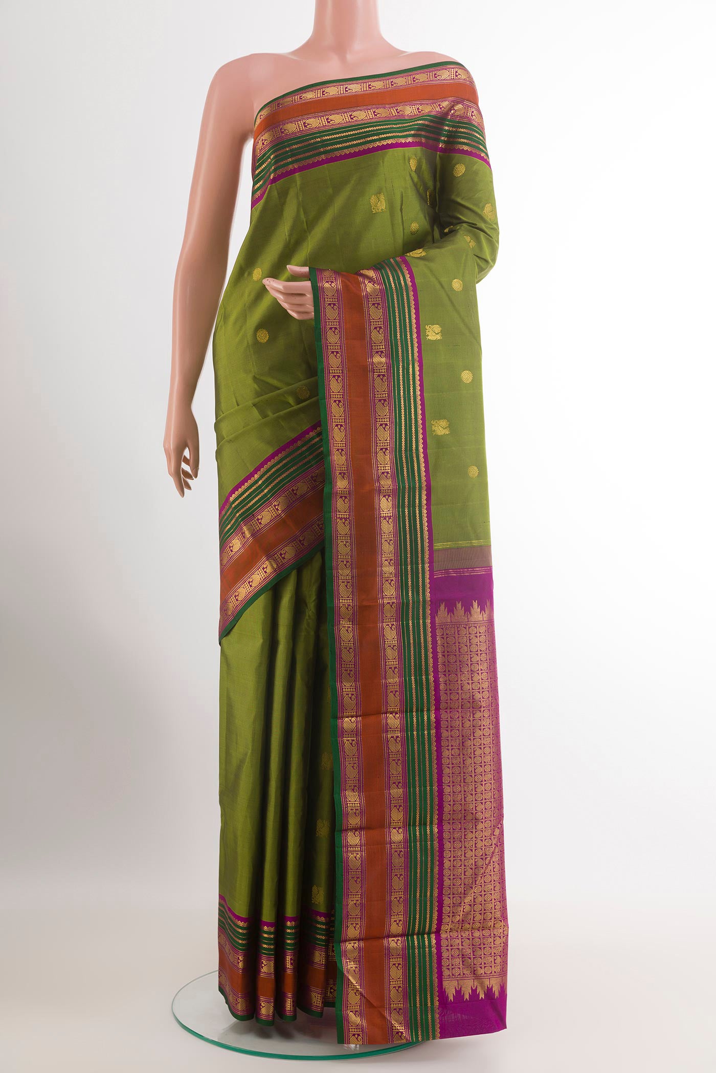 Green Kanchipuram Silk Saree with Zari Butta on the body and Zari Border.  displayed on a mannequin