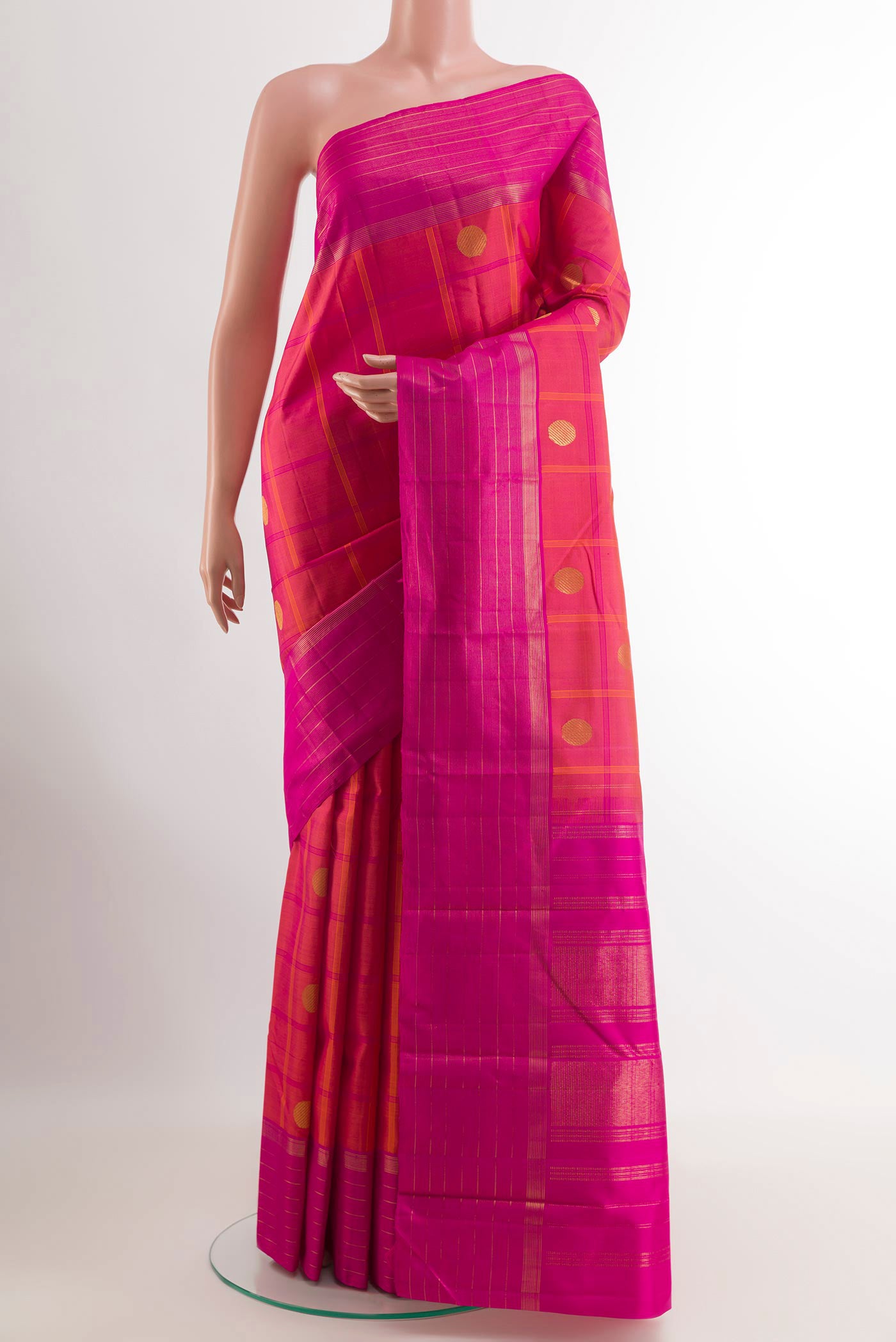 Peach Kanchipuram Silk Saree with Zari Butta on the body and Zari Border.  displayed on a mannequin