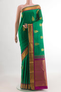 Green Kanchipuram Silk Saree with Zari Butta on the body and Zari Border.  displayed on a mannequin