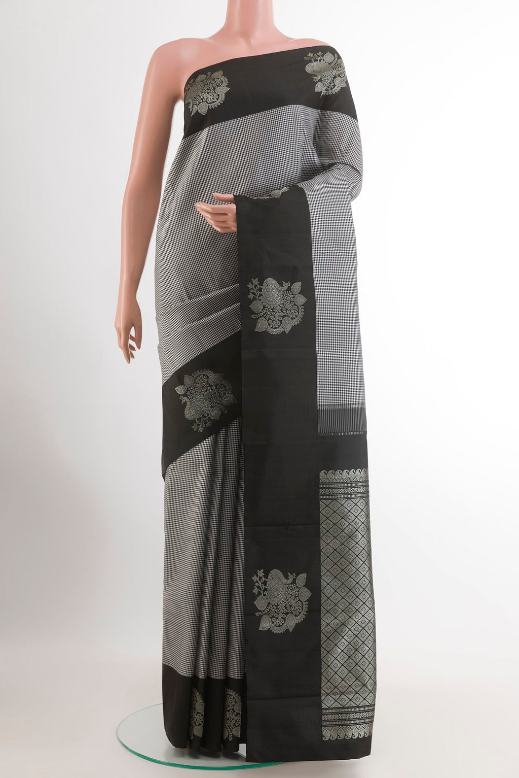 White Kanjivaram Silk Saree with Checked design on the body and Zari Border.  displayed on a mannequin