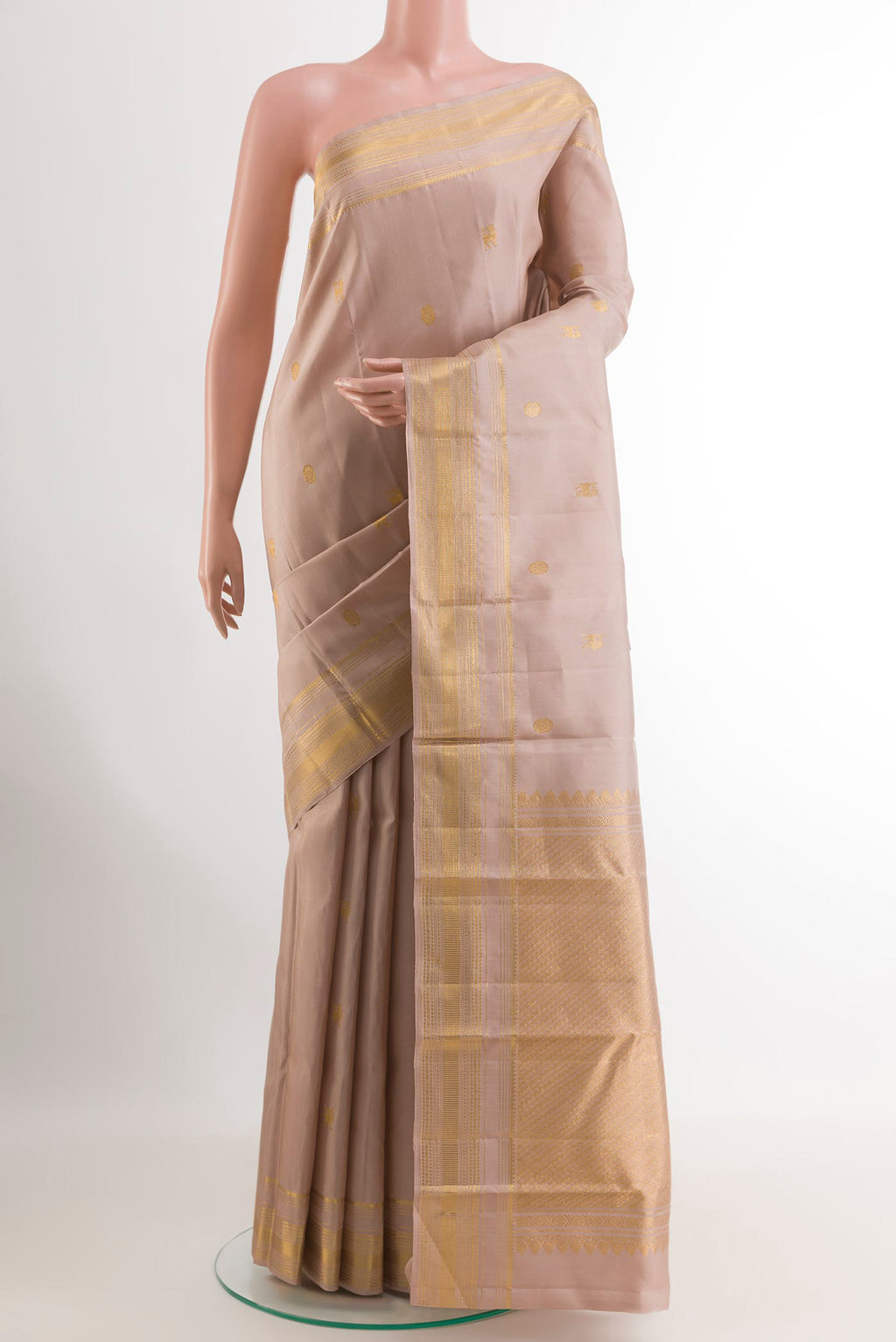 Cream Kanchipuram Silk Saree with Zari Butta on the body and Zari Border.  displayed on a mannequin