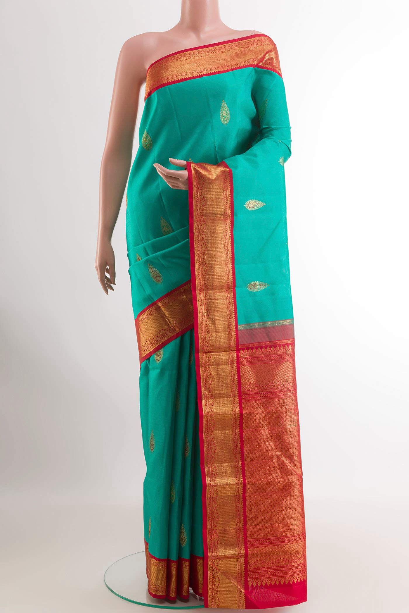 Sea Green Kanjivaram Silk Saree with Zari Butta on the body and Zari Border.  displayed on a mannequin