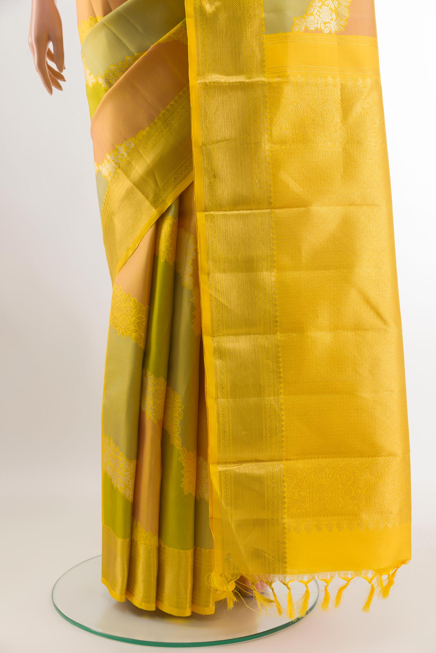 Pleats and pallu of Yellow Kanchipuram Silk Saree with Zari Brocade on the body and Zari Border. 