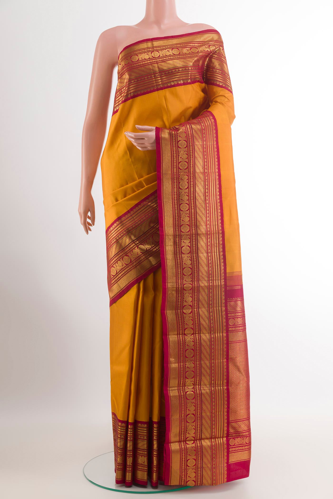Yellow Kanjivaram Silk Saree with Plain Body and Zari Border.  displayed on a mannequin