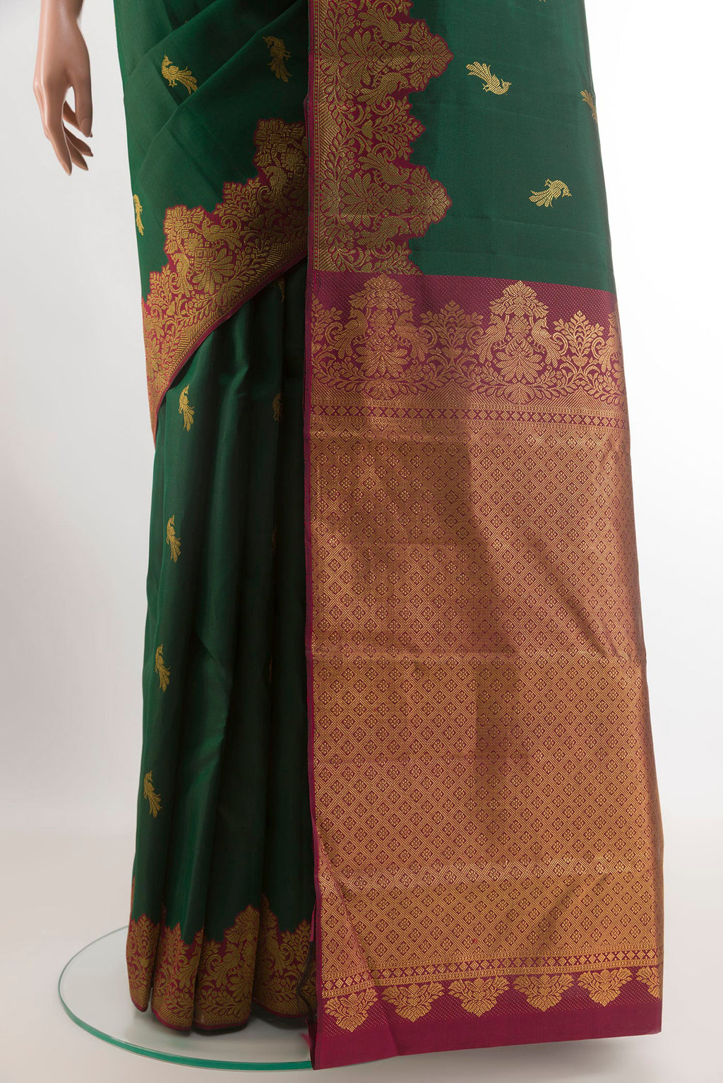 Pleats and pallu of Bottle Green Kanchipuram Silk Saree with Zari Butta on the body and Zari Border. 