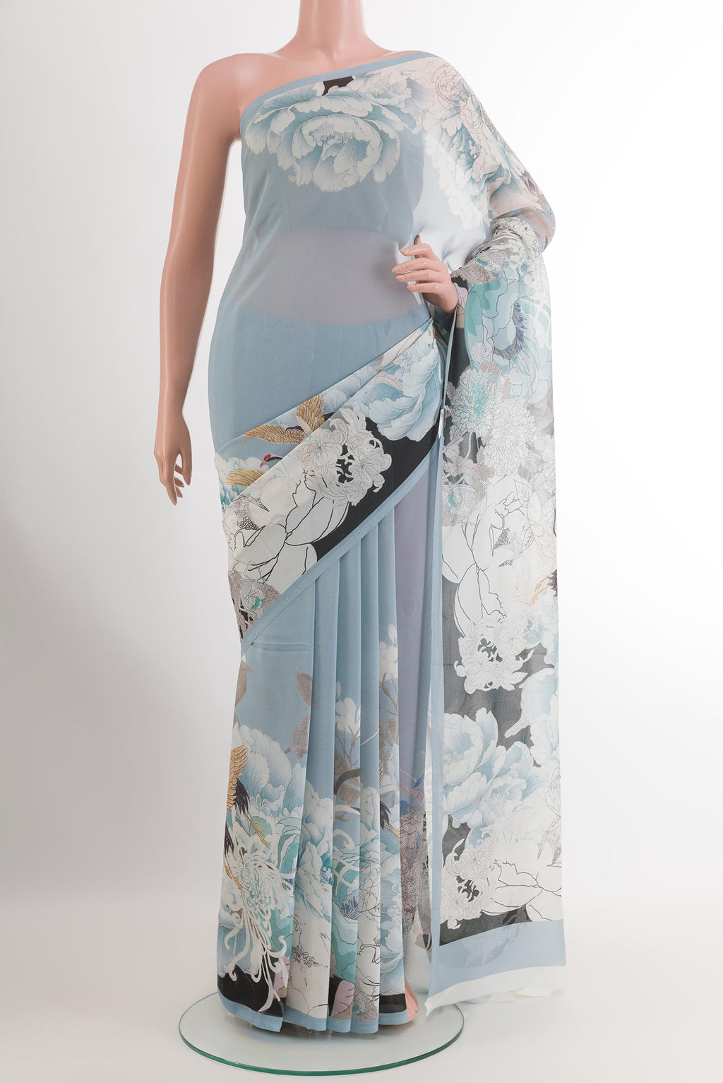 Blue Chiffon Saree with Printed design on the body and Plain Border.  displayed on a mannequin