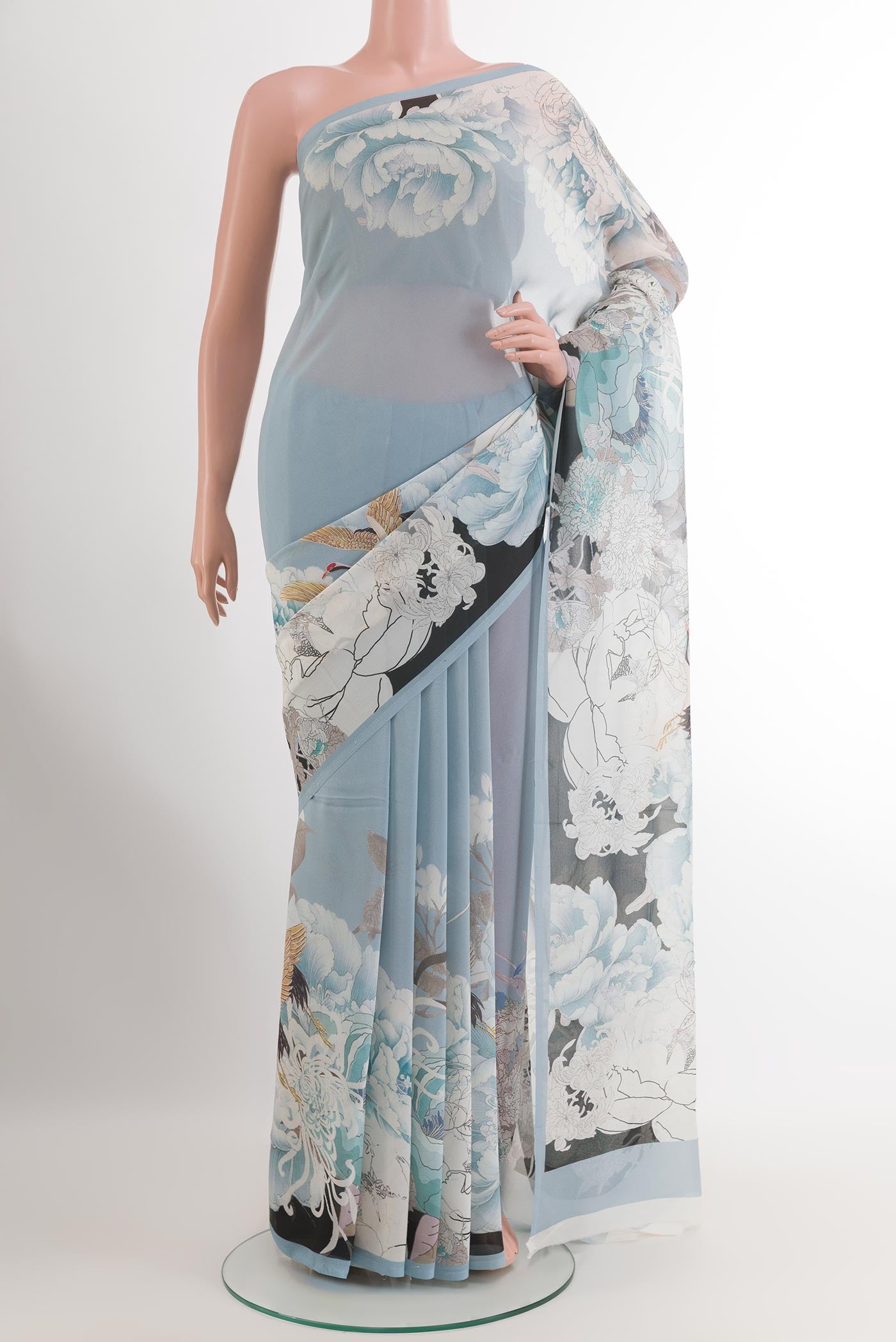 Blue Chiffon Saree with Printed design on the body and Plain Border.  displayed on a mannequin