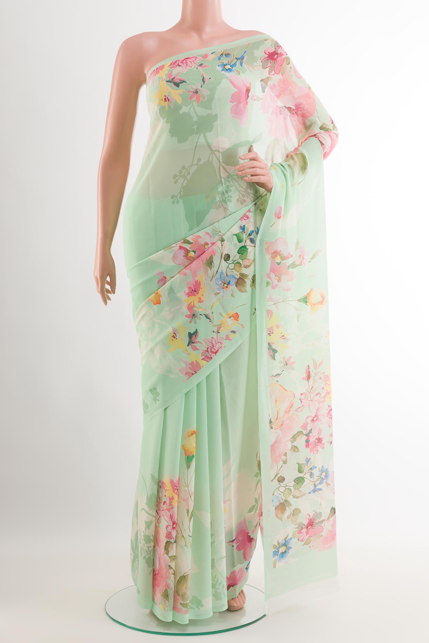 Light Green Chiffon Saree with Printed design on the body and Plain Border.  displayed on a mannequin