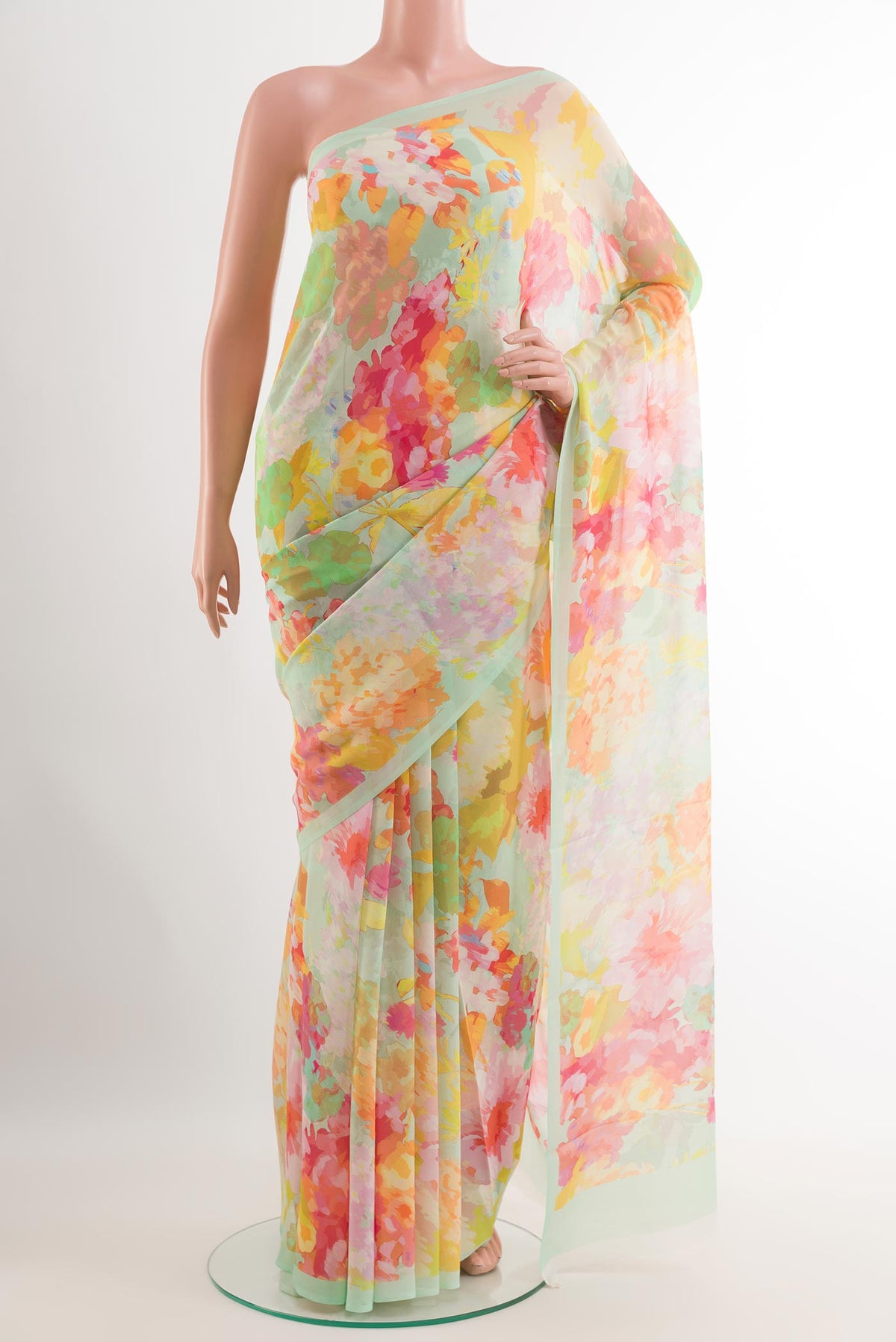 Light Green Chiffon Saree with Printed design on the body and Plain Border.  displayed on a mannequin