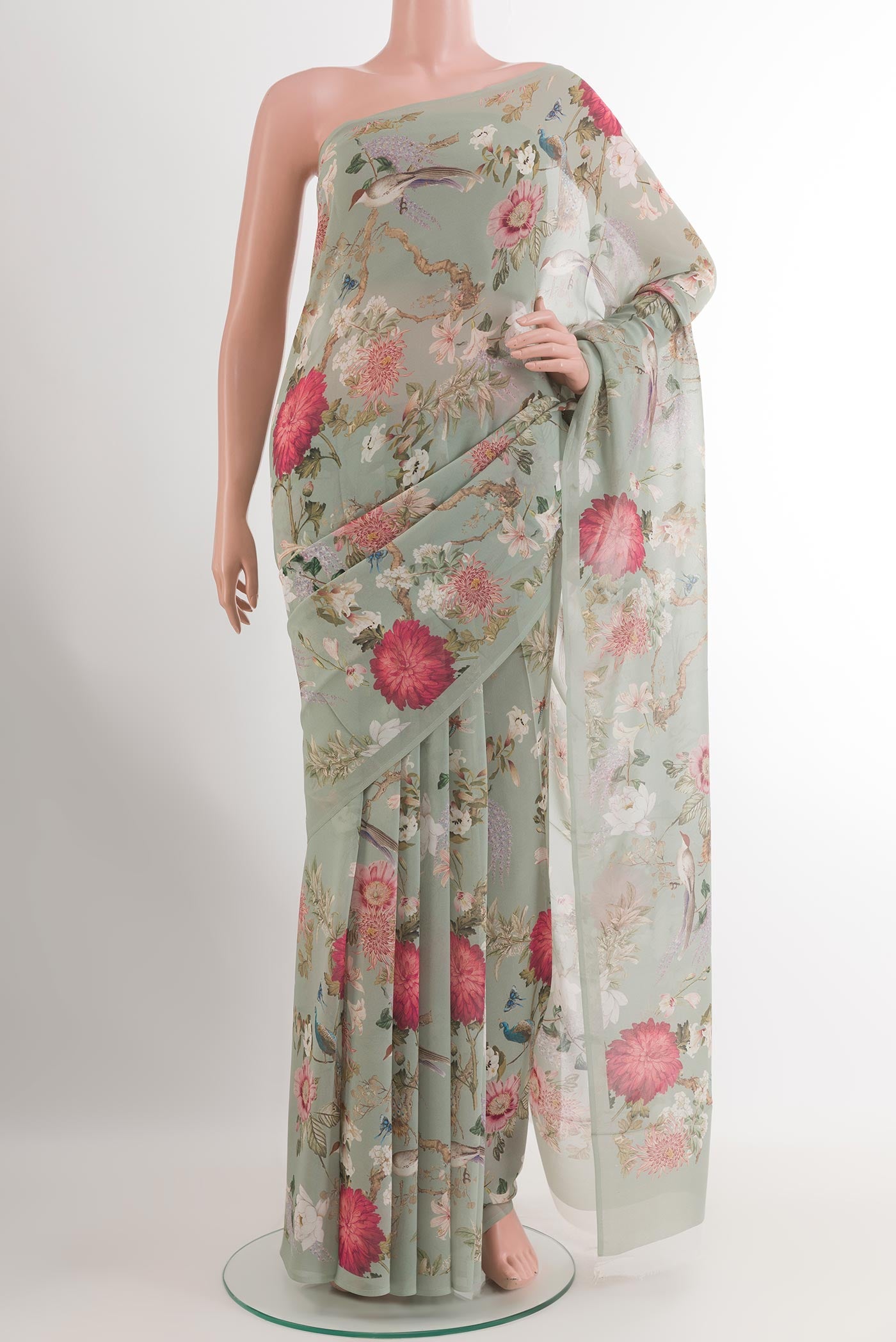 Green Chiffon Saree with Printed design on the body and Plain Border.  displayed on a mannequin