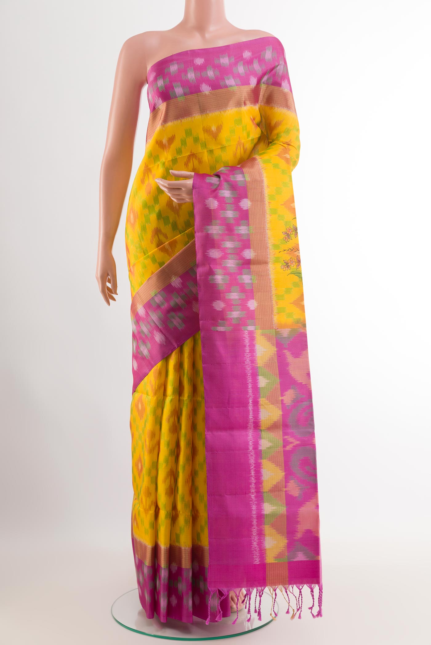 Yellow Soft Silk Saree with Pure Ikat on the body and Zari Border.  displayed on a mannequin