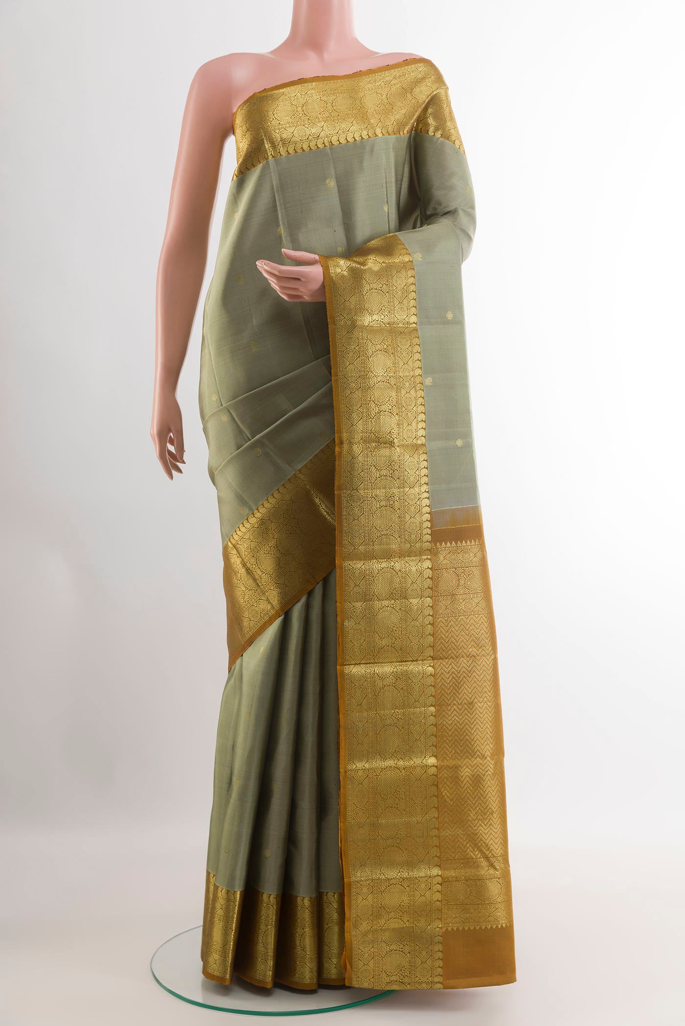 Grey Kanchipuram Silk Saree with Zari Butta on the body and Zari Border.  displayed on a mannequin
