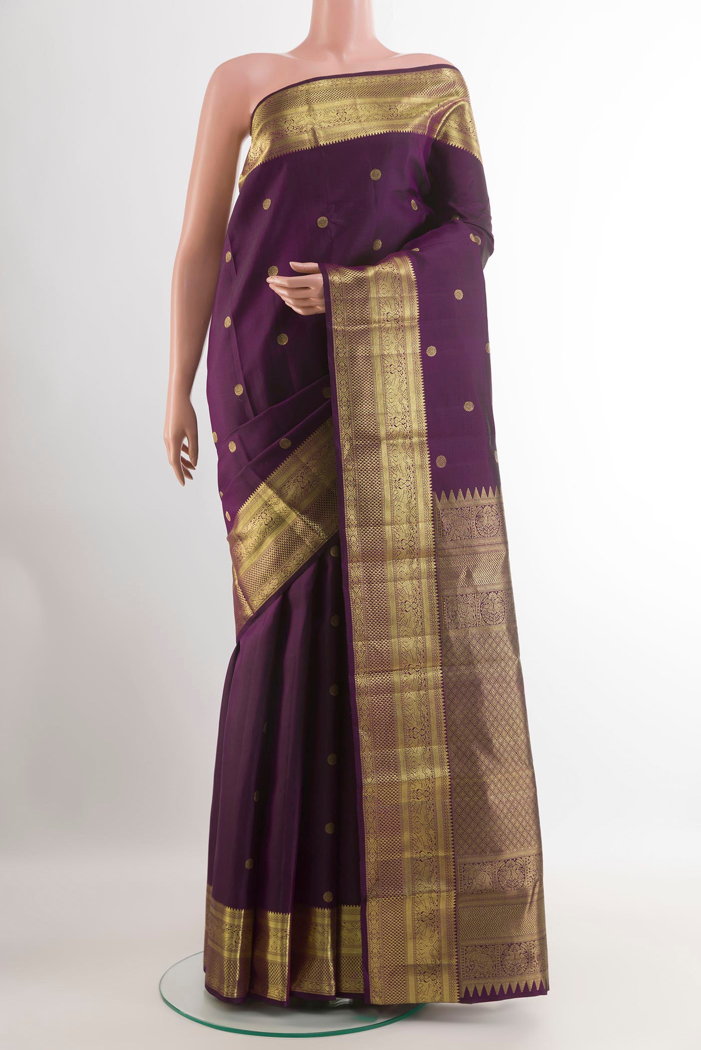 Purple Kanchipuram Silk Saree with Zari Butta on the body and Zari Border.  displayed on a mannequin
