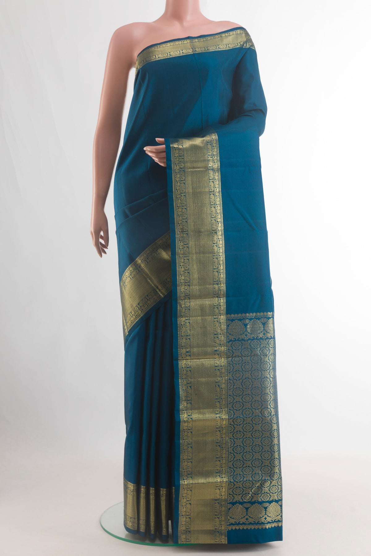 Pure Silk Blue Kanjivaram Saree with Plain Body and Zari Border.  displayed on a mannequin