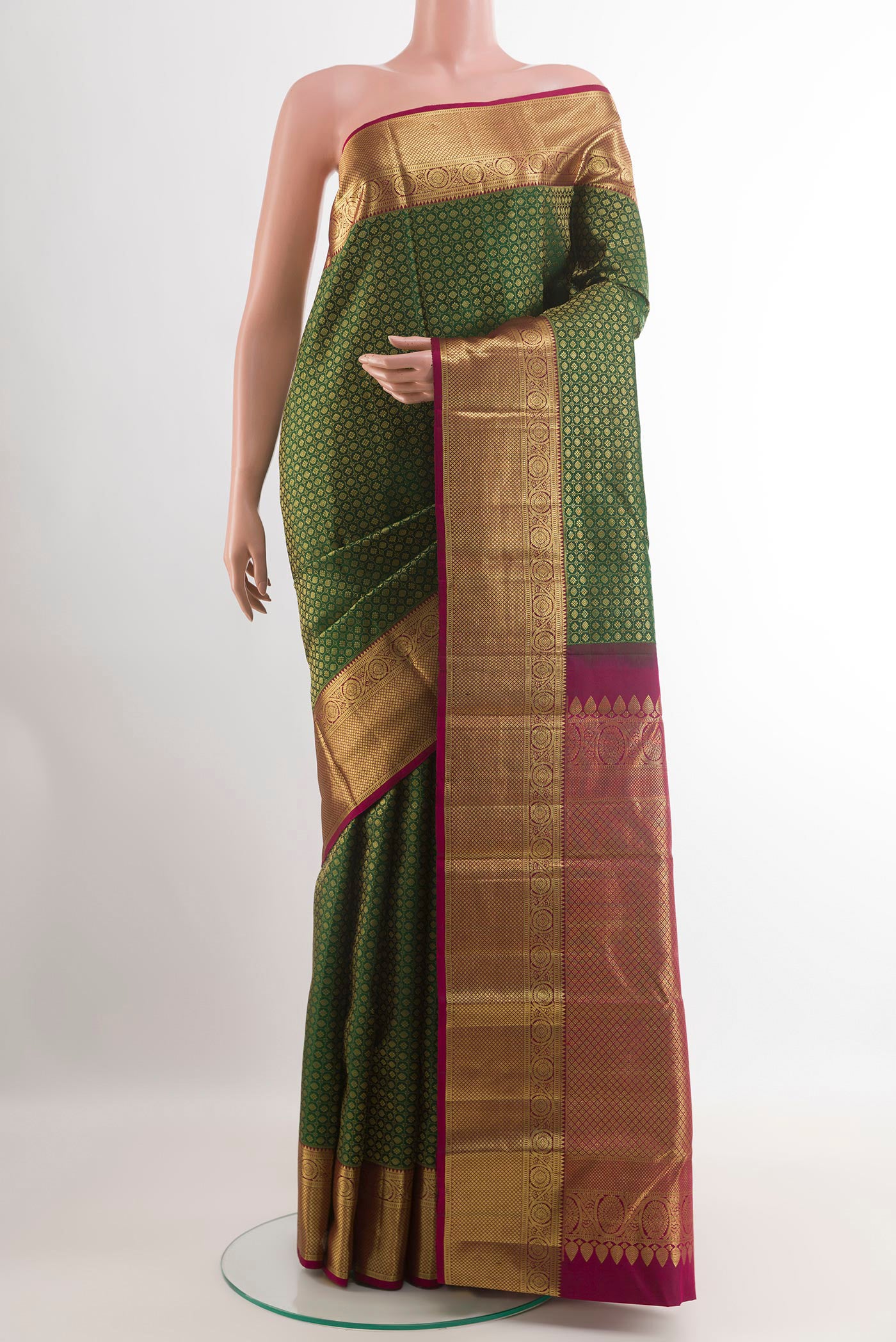 Green Kanjivaram Silk Saree with Zari Brocade on the body and Zari Border.  displayed on a mannequin