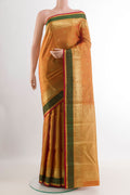 Mustard Kanjivaram Silk Saree with Zari Butta on the body and Zari Border.  displayed on a mannequin
