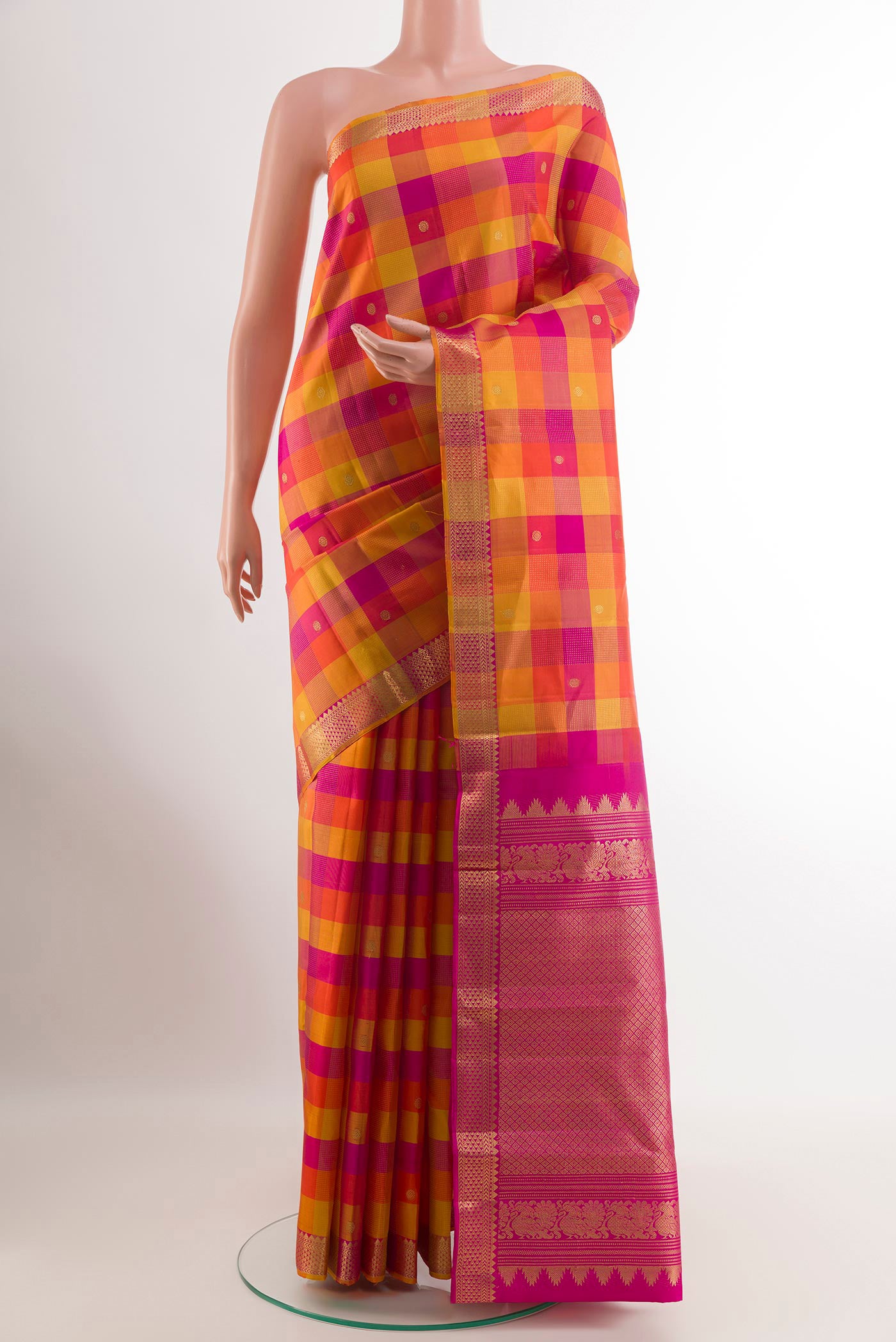 Multi Color Kanjivaram Silk Saree with Zari Butta on the body and Zari Border.  displayed on a mannequin